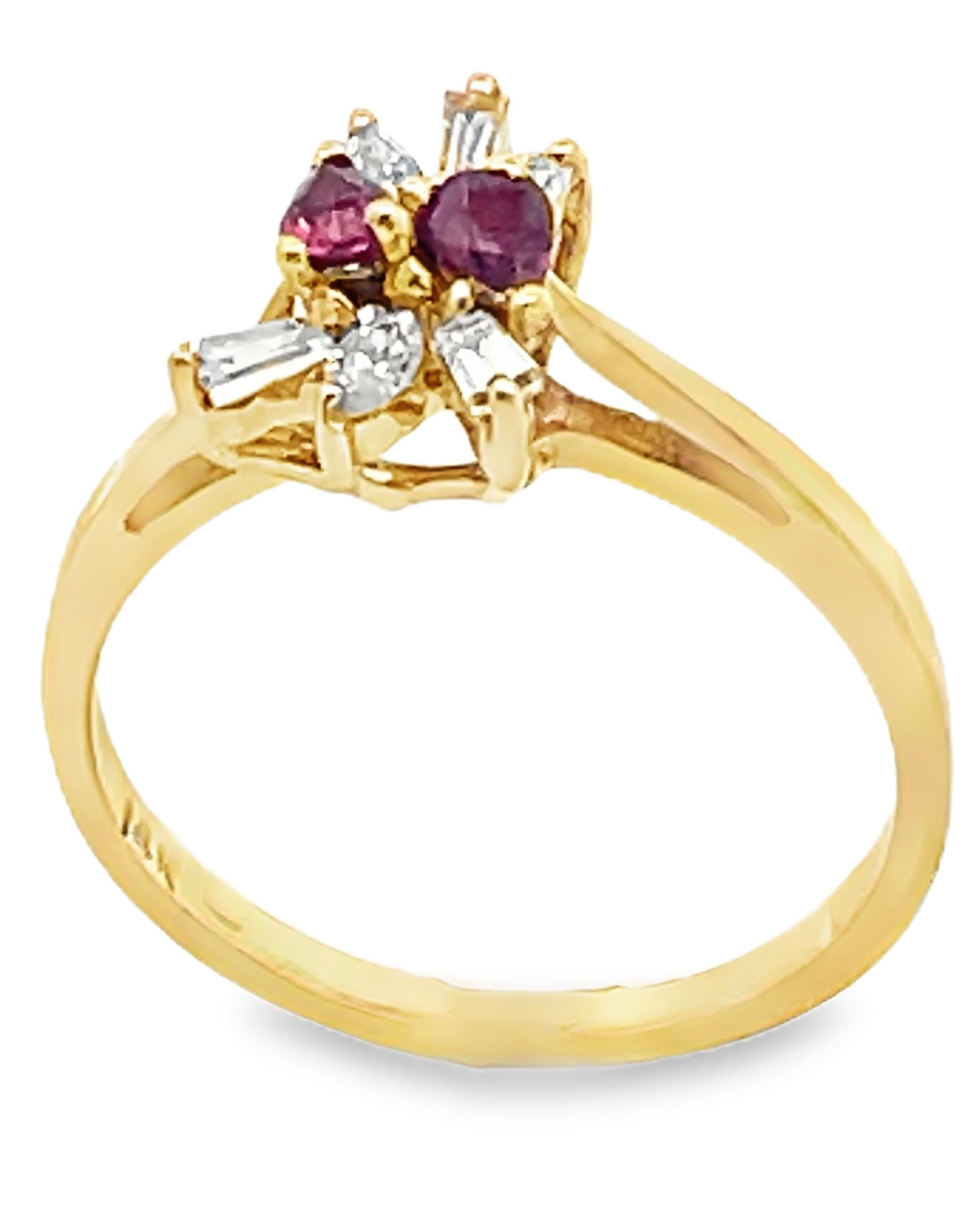 14K yellow gold ring with diamonds weighing 0.26 carat total with two pear-shaped rubies weighing 0.21 carat total. 

- Finger size 6.5, can be sized up or down by up to 2 sizes
