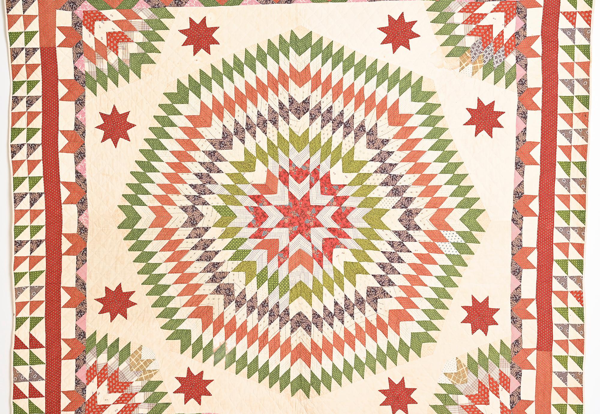 Calico Starburst quilt; Circa 1880; Pennsylvania origin. Splashy starburst quilt with many additional patterns. The corners hold the pattern together while LeMoyne Stars dance around the perimeter. Half stars and two rows of triangles make for