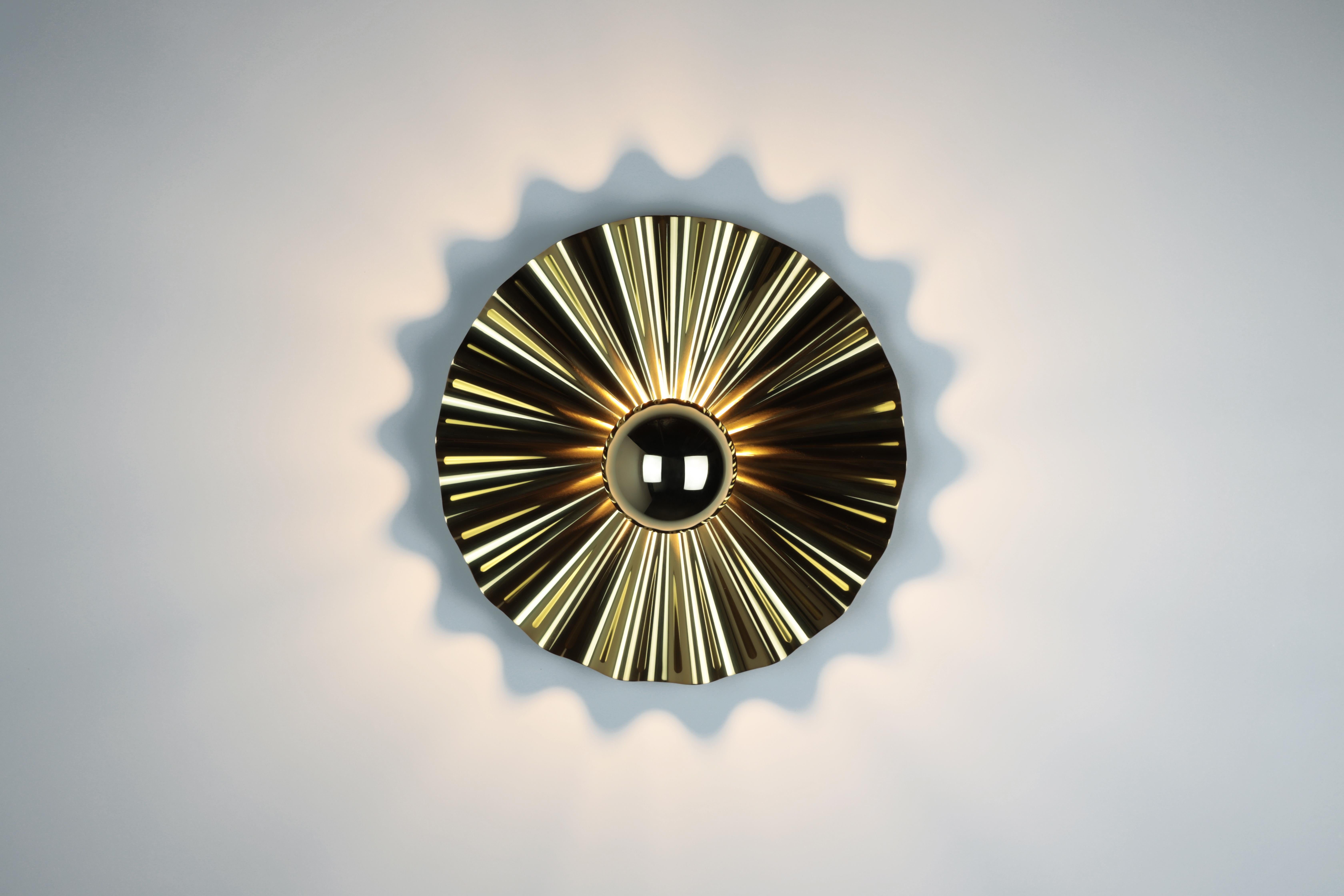 An explosion of light reflects and spills onto the wall from a corrugated metal surface. The starburst sconce is made of PVD polished stainless steel with a medium socket bulb. A half dipped gold bulb is included.
Made in Los Angeles.