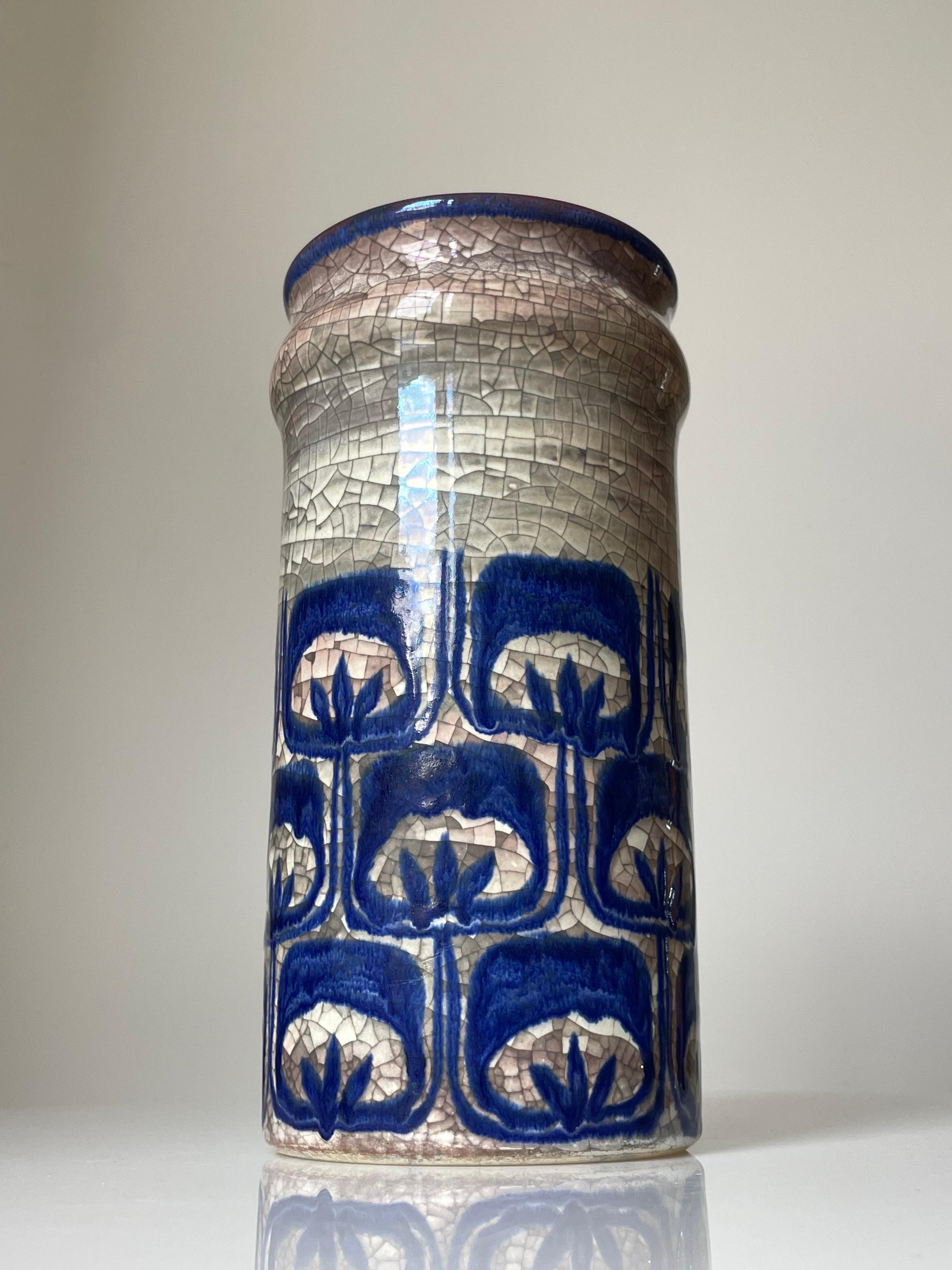 Danish midcentury modern ceramic vase by Marianne Starck for Michael Andersen & Son. Blue stylized floral decor around the belly of the grey cylinder shape with persia crackle glaze with slight burgundy tint. The inside glazed in burgundy, blue and