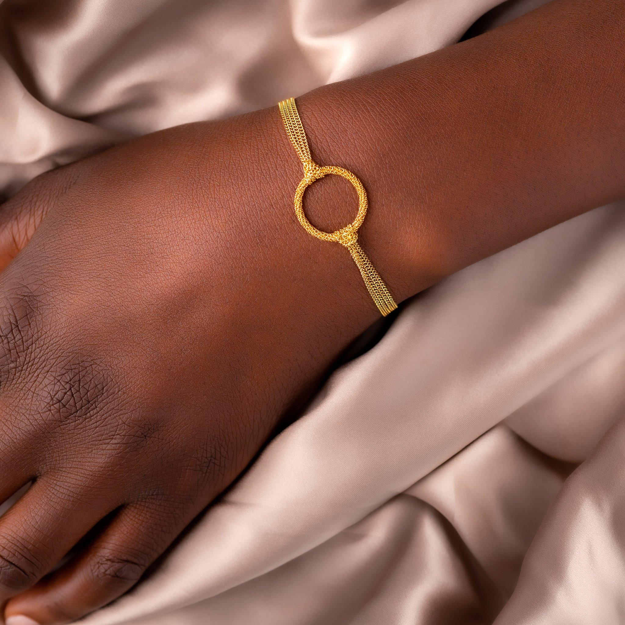 This deceptively simple bracelet has a secret: the links of its handmade, diamond-cut 18K yellow gold chains have the ability to reflect ambient light so brilliantly that you’ll think you’re wearing slender rivers of glimmering starlight. The two