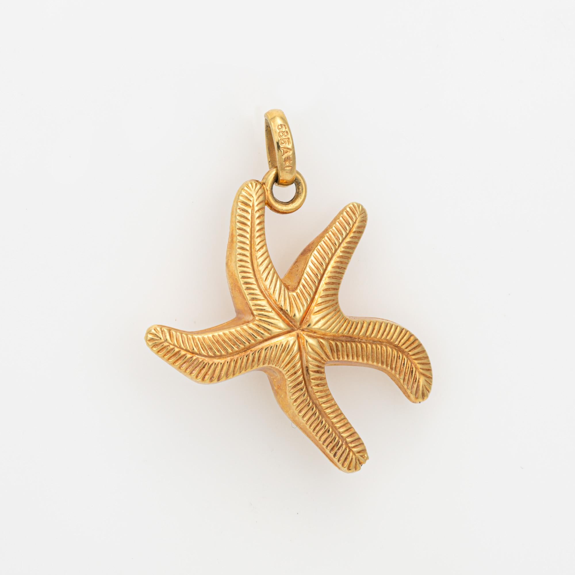 Finely detailed vintage Starfish charm crafted in 14k yellow gold.  

The nicely detailed starfish is rendered in lifelike detail with green and red enamel details. The starfish is hollow and light to the touch at 2.1 grams. 

The charm is in very