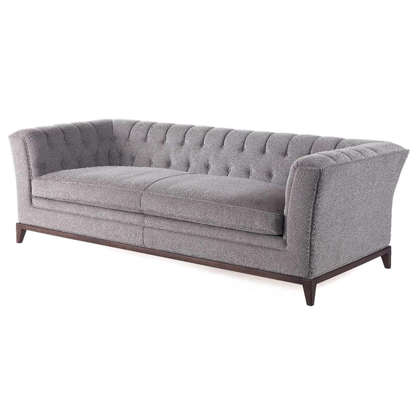 The tailored look of the Stark Sofa will add elegance in a modern living room or study offering sheltering comfort. Upholstered in light-gray fabric, the squared-off frame is detailed with a soft continuous button-tufted back and angled arms. The