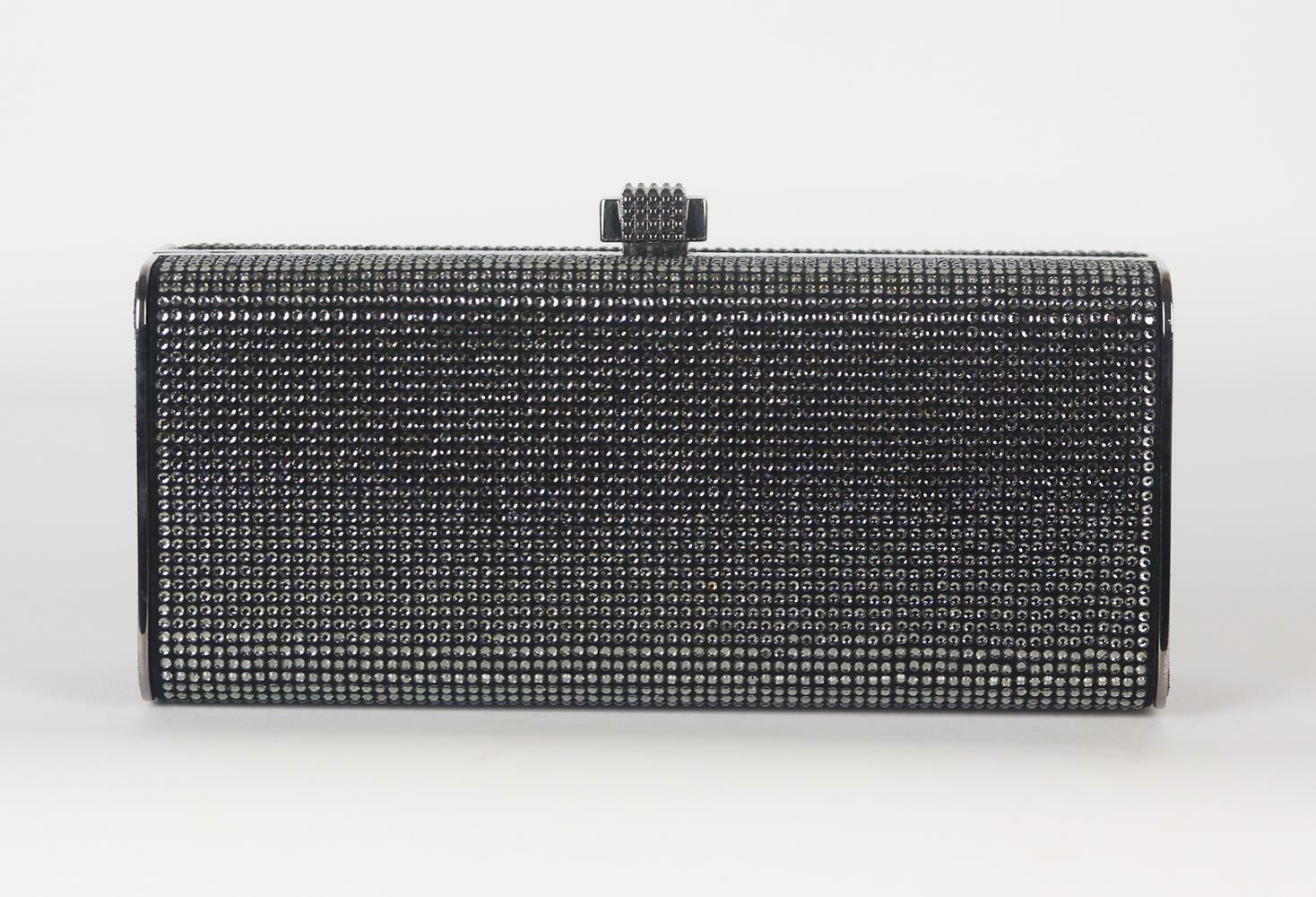 Stark's clutch has a sleek, streamlined shape that will fit easily in your hand or under the arm, made from suede and metal, it's embellished with crystals throughout and is lined in black leather to keep essentials protected.
Metallic crystal,
