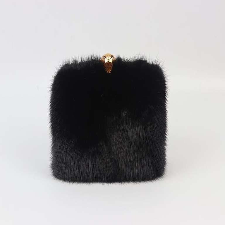 Stark mink fur and suede box clutch. Black. Push lock fastening at top. Comes with dustbag. Height: 3.8 in. Width: 5.7 in. Depth: 2 in. Very good condition - No sign of wear; see pictures