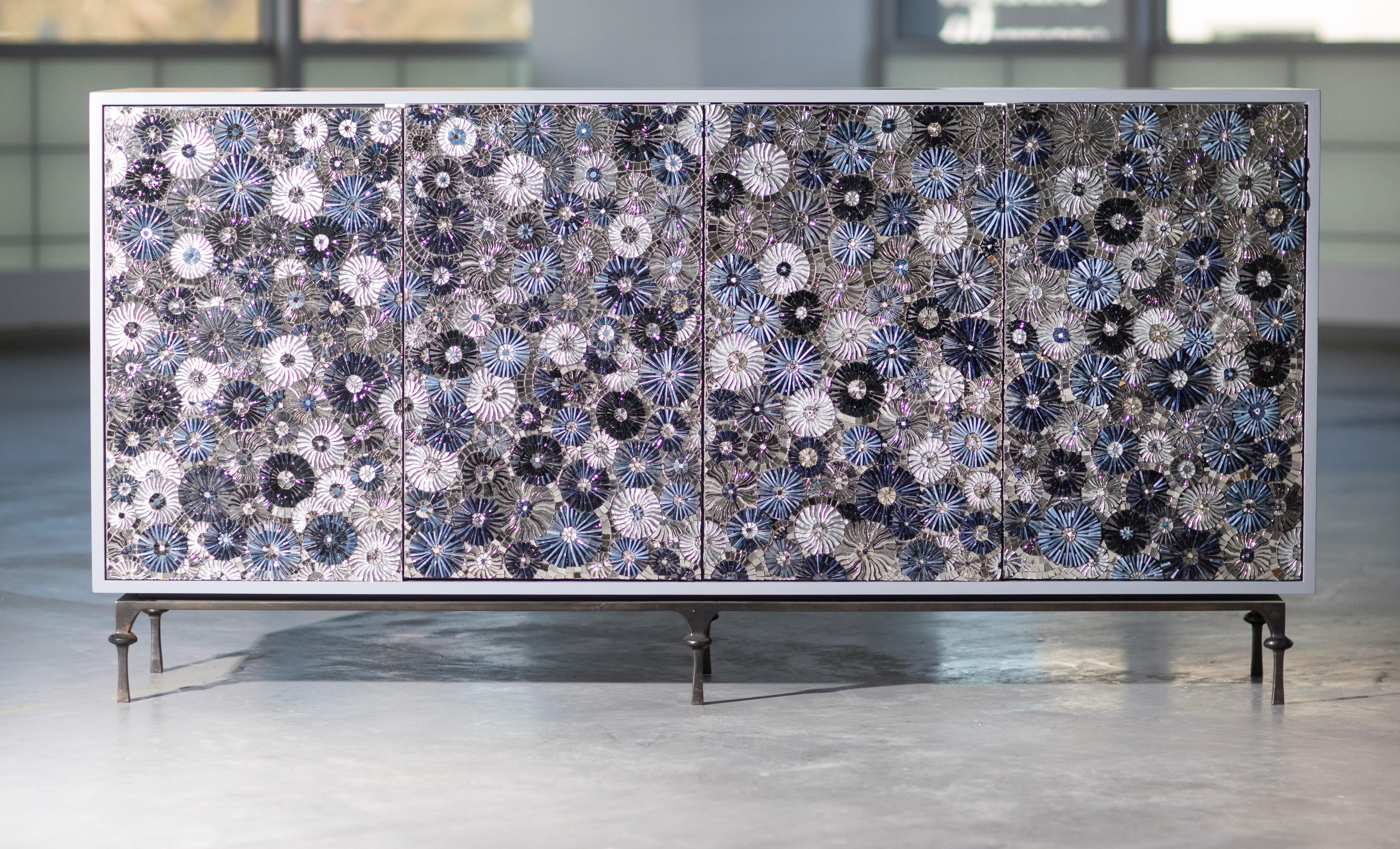 This show stopping 4 door Buffet by Ercole Home is a sparkling new addition to our Blossom Collection. This buffet is made up of two compartments, 4 drawers, and adjustable shelves. The touch latch doors are adorned in a mixture of deep blues and a