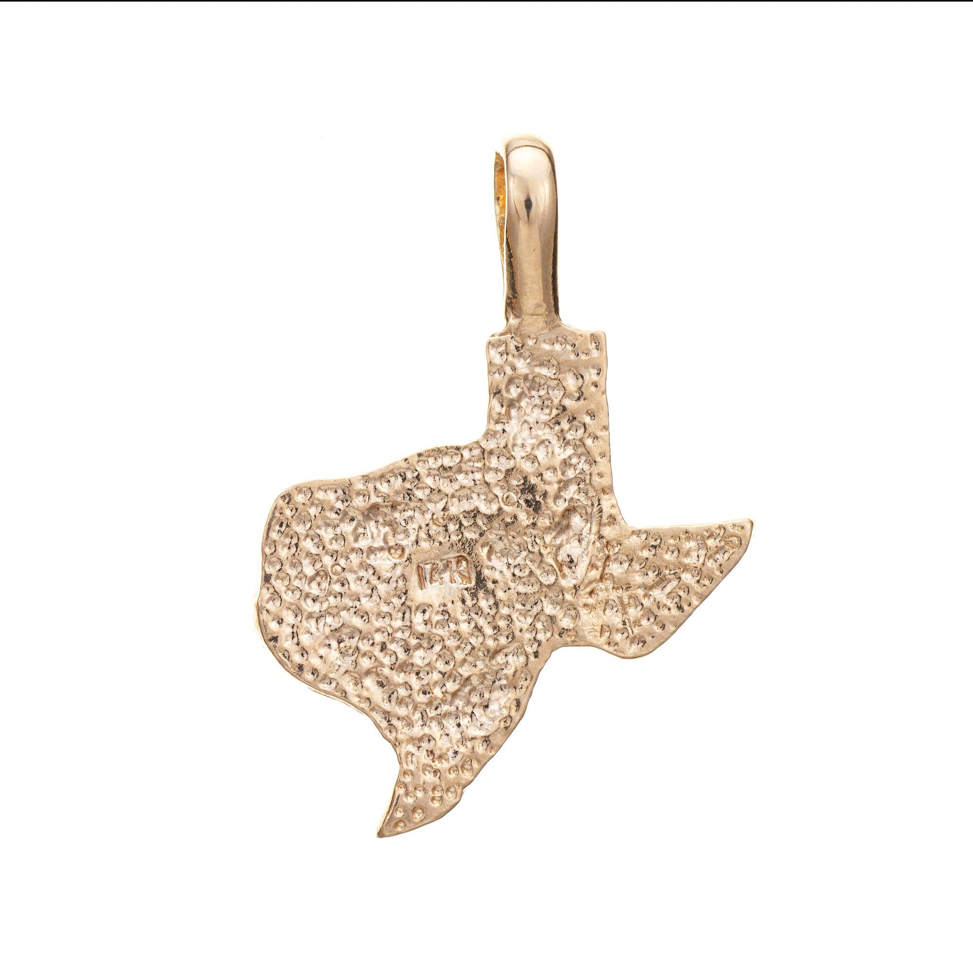 Finely detailed vintage State of Texas charm crafted in 14k yellow gold (circa 1970s).  

The ornate nugget style charm highlights the State of Texas. The piece can be worn as a charm on a bracelet or as a pendant on a chain.

The charm is in very