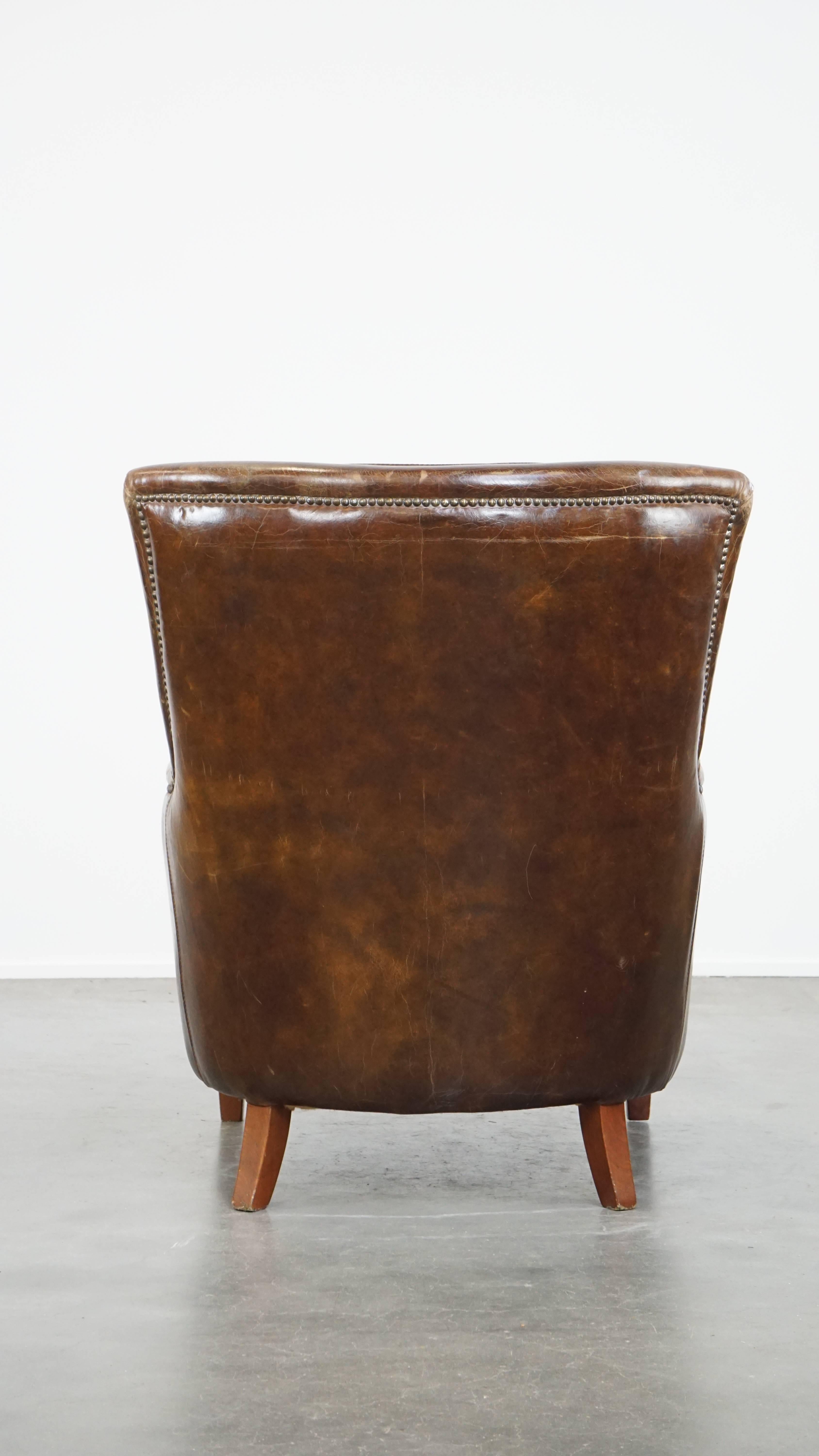 Stately and comfortable grained cowhide armchair with a timeless design In Fair Condition For Sale In Harderwijk, NL