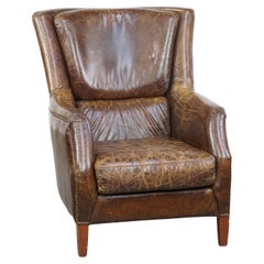Stately and comfortable grained cowhide armchair with a timeless design