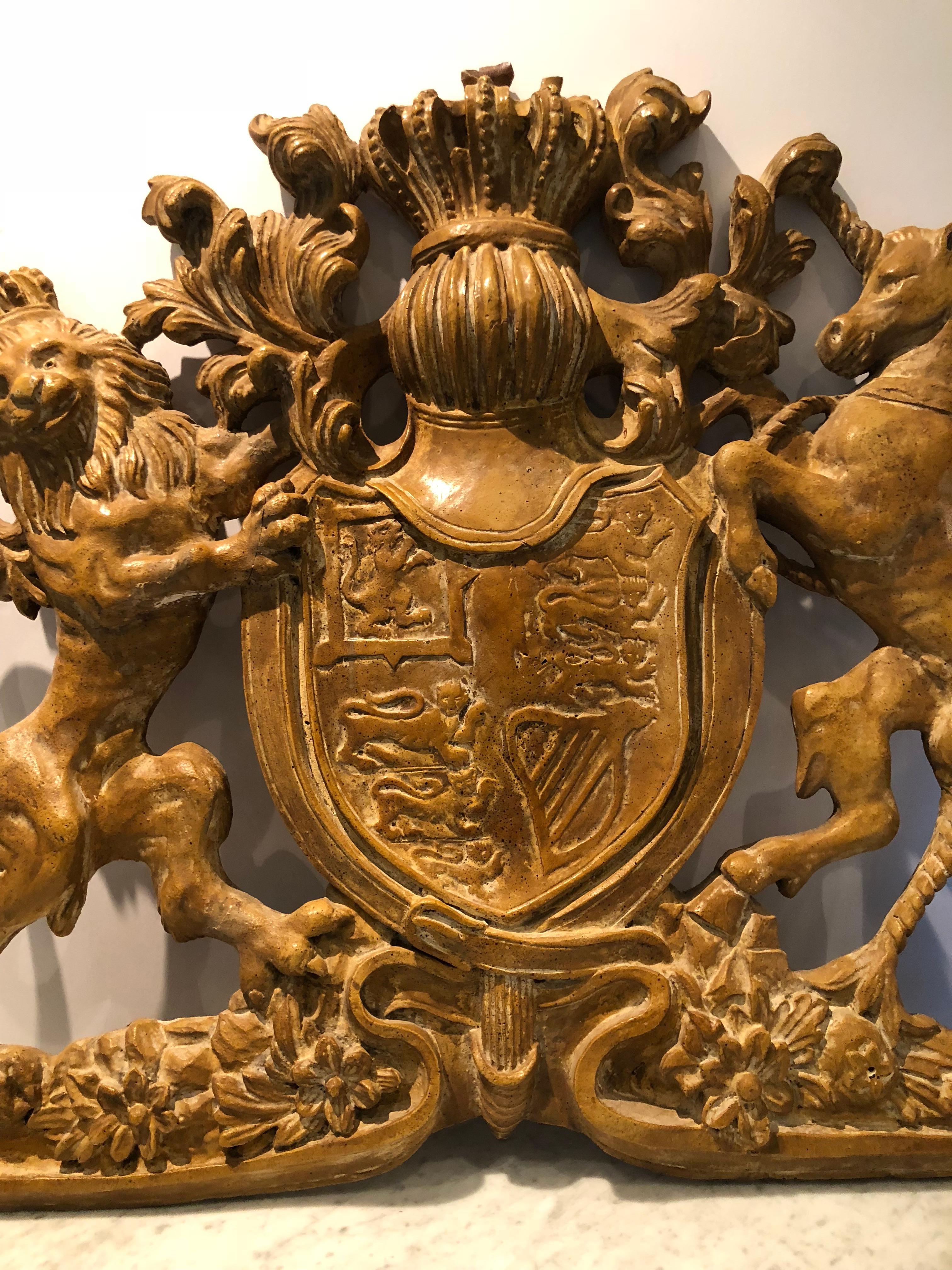 Stately and beautifully detailed Coat of Arms made from an original casting. This composite piece depicts a crowned lion, a horse and a shield decorated with griffins. Makes a statement due to its size and detail; perfect for a library or den.