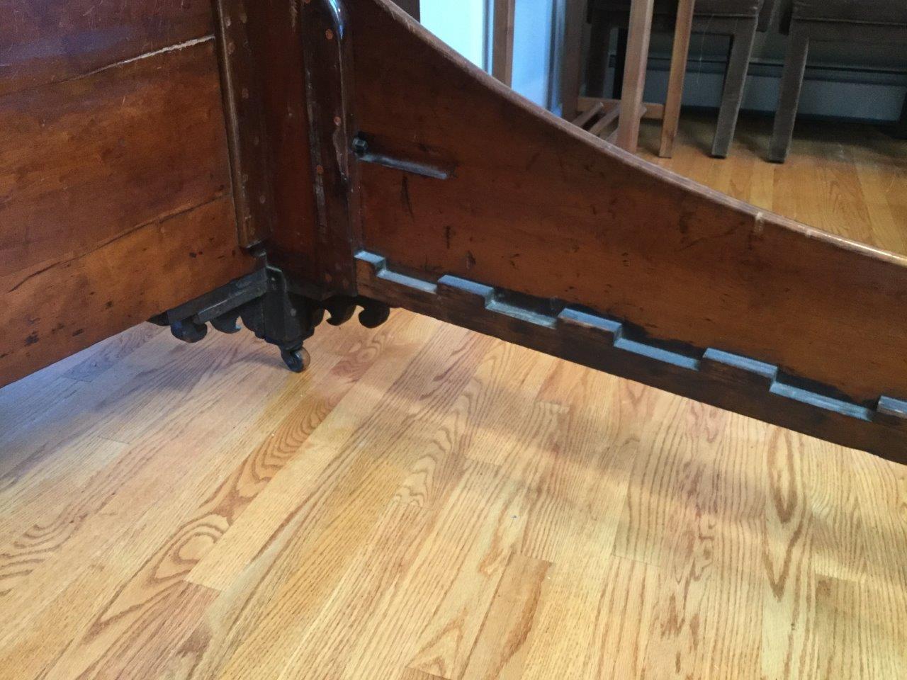 Handsome and elegant describe this early 20th century English Scottish sleigh bed. Made of flame mahogany, this bed will accommodate a full mattress. The head and footboard are of the same height and the side rails are both finished and very