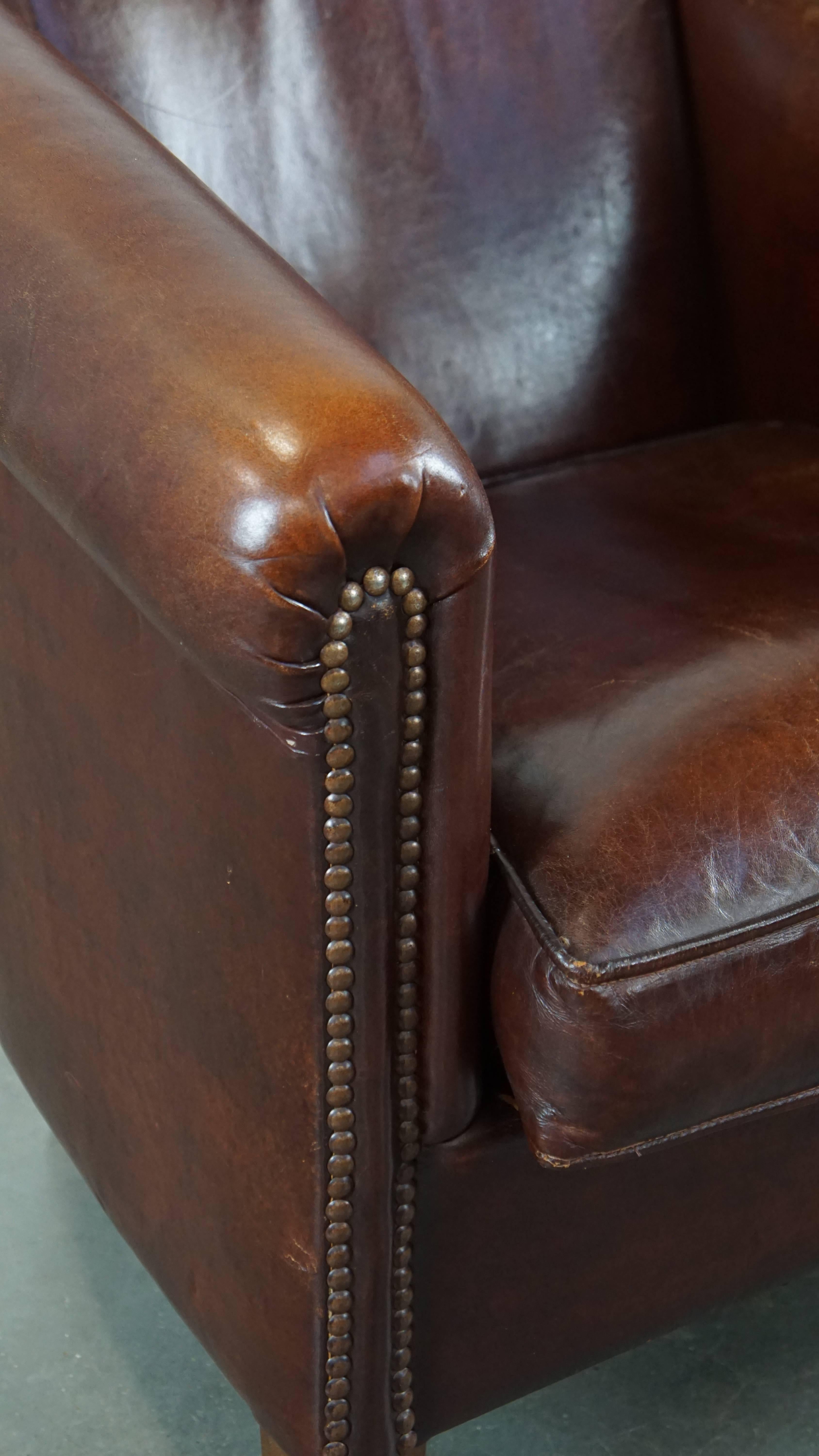 Stately, charming sheepskin club chair, correct finishing with decorative nails For Sale 5
