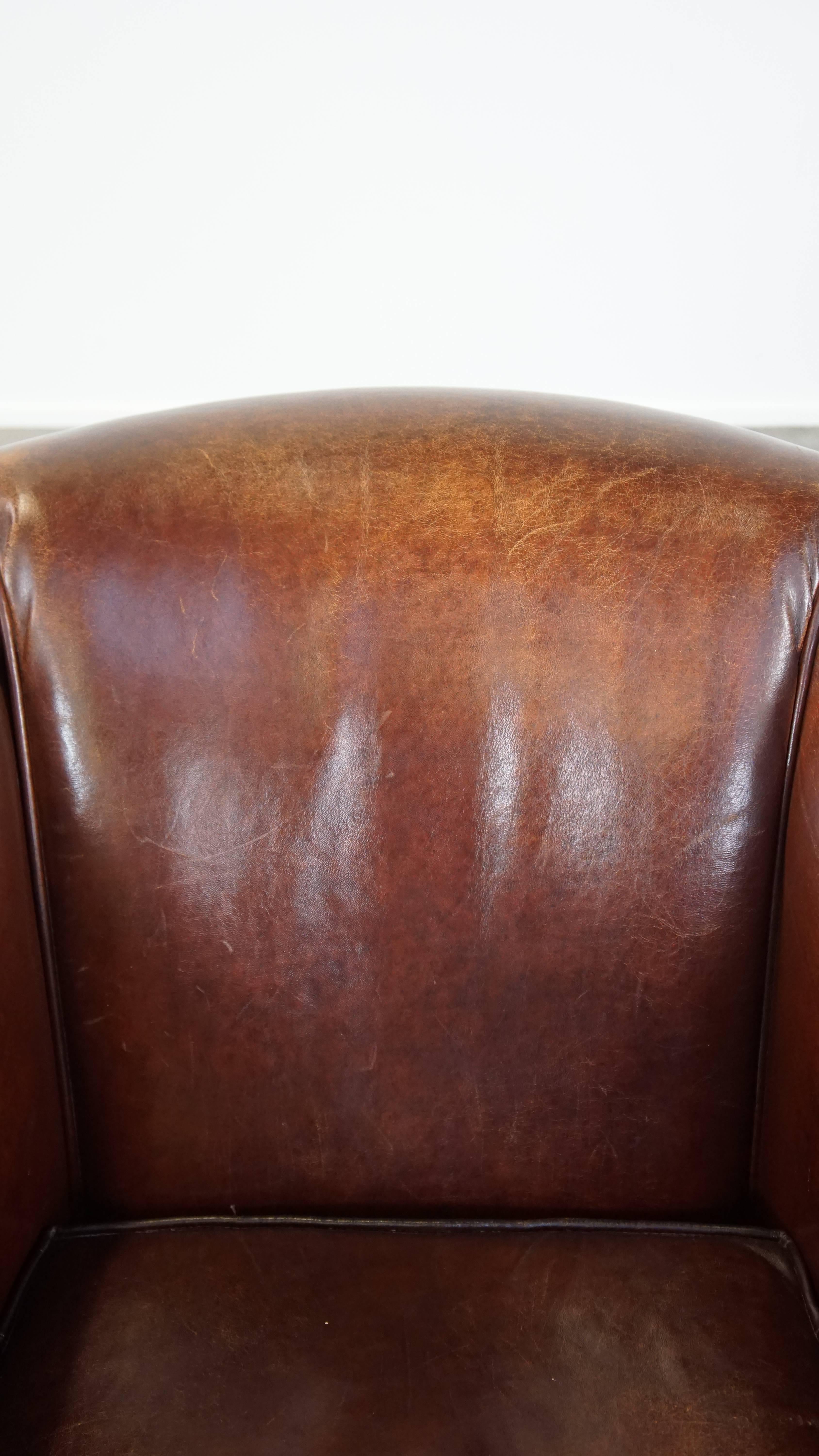 Stately, charming sheepskin club chair, correct finishing with decorative nails For Sale 7