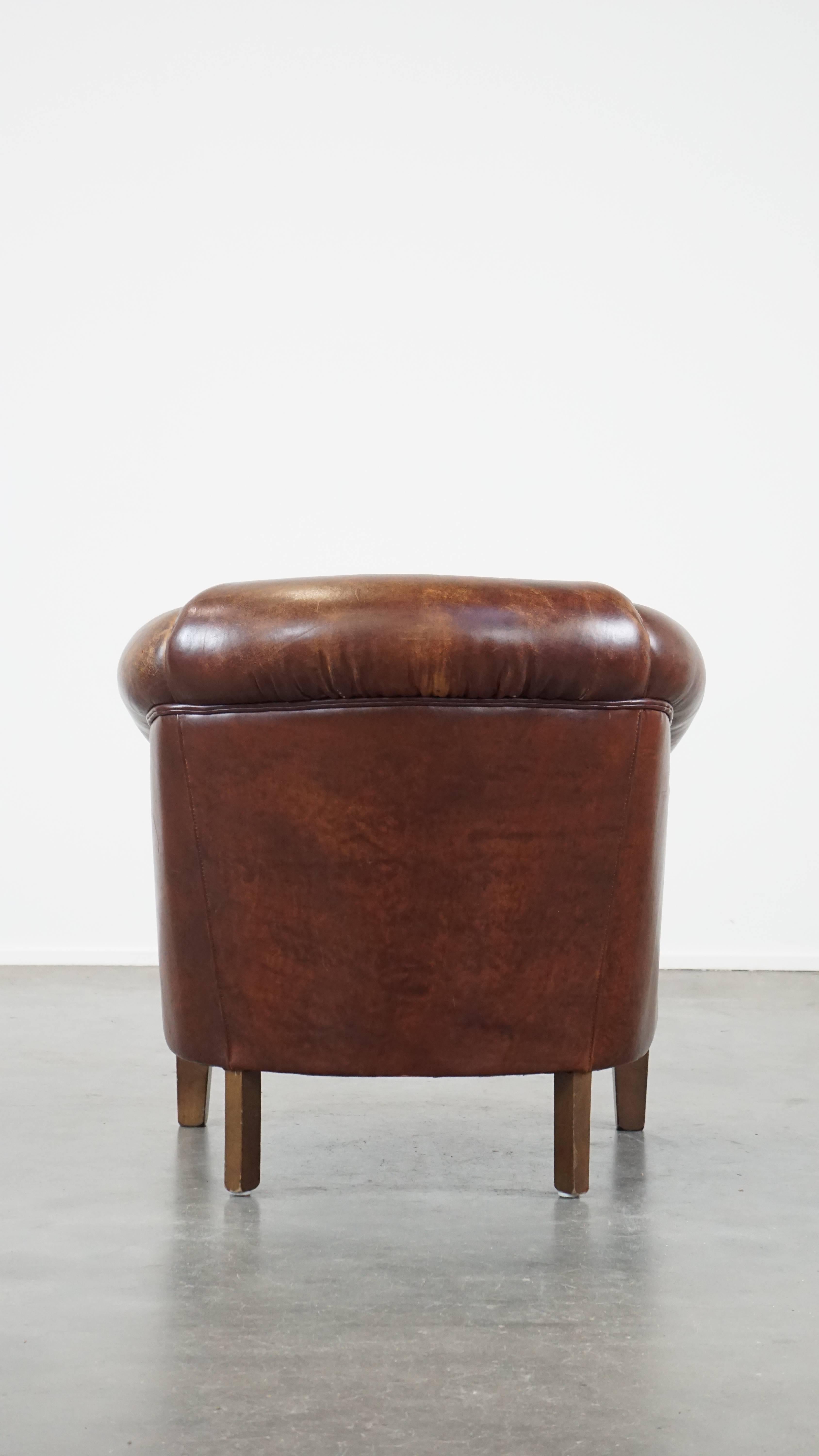 Hand-Crafted Stately, charming sheepskin club chair, correct finishing with decorative nails For Sale