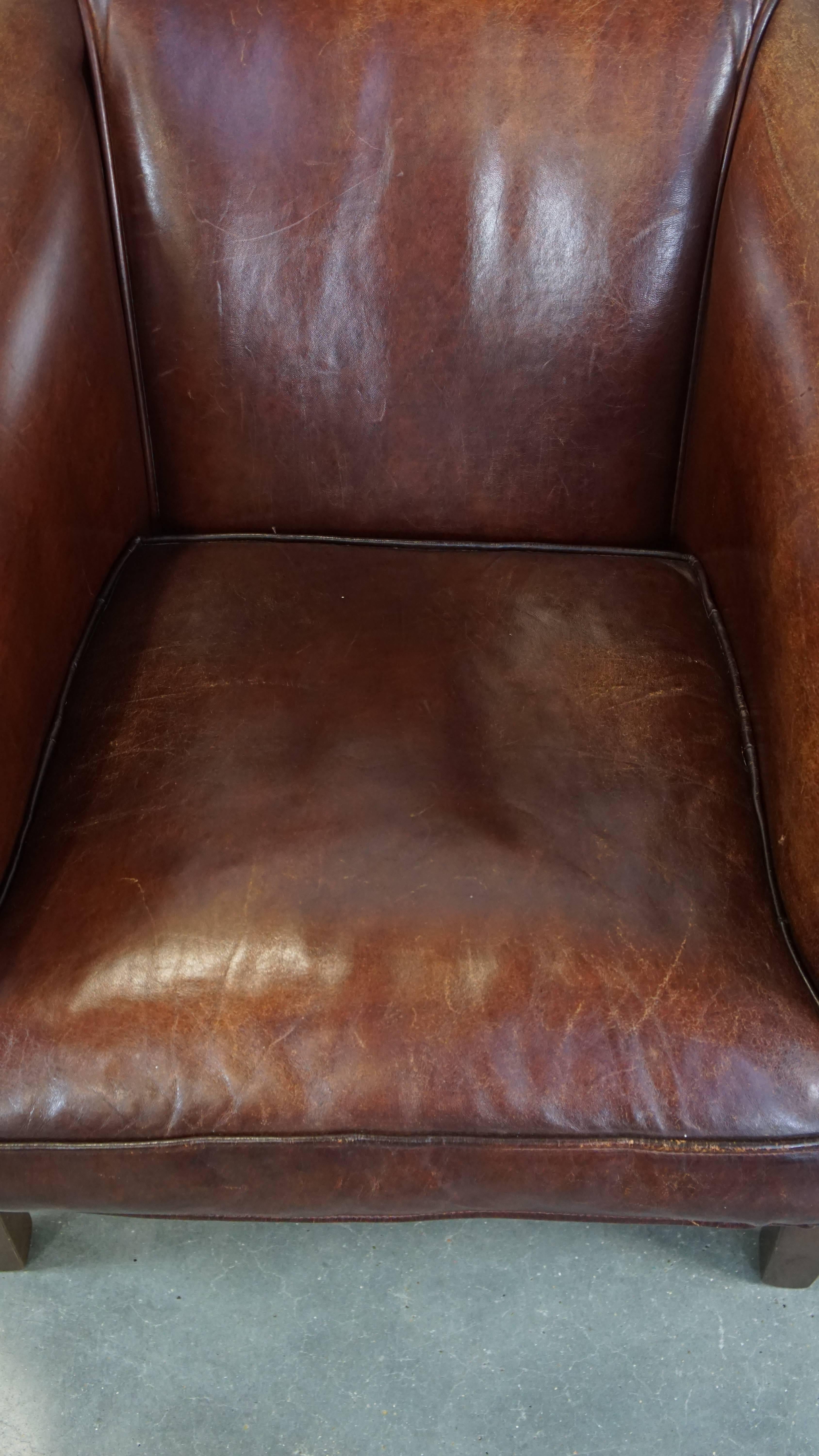 20th Century Stately, charming sheepskin club chair, correct finishing with decorative nails For Sale