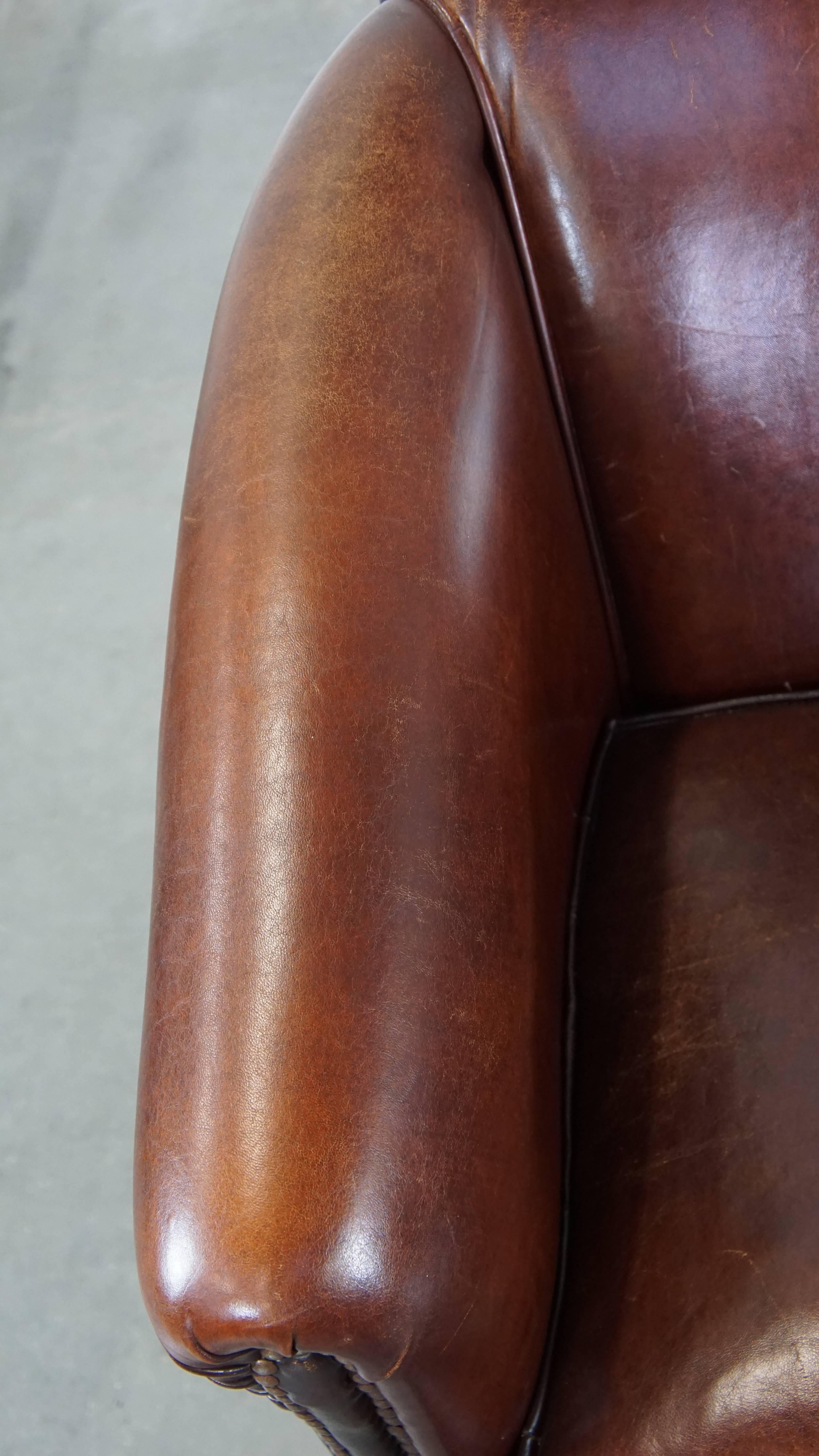 Sheepskin Stately, charming sheepskin club chair, correct finishing with decorative nails For Sale