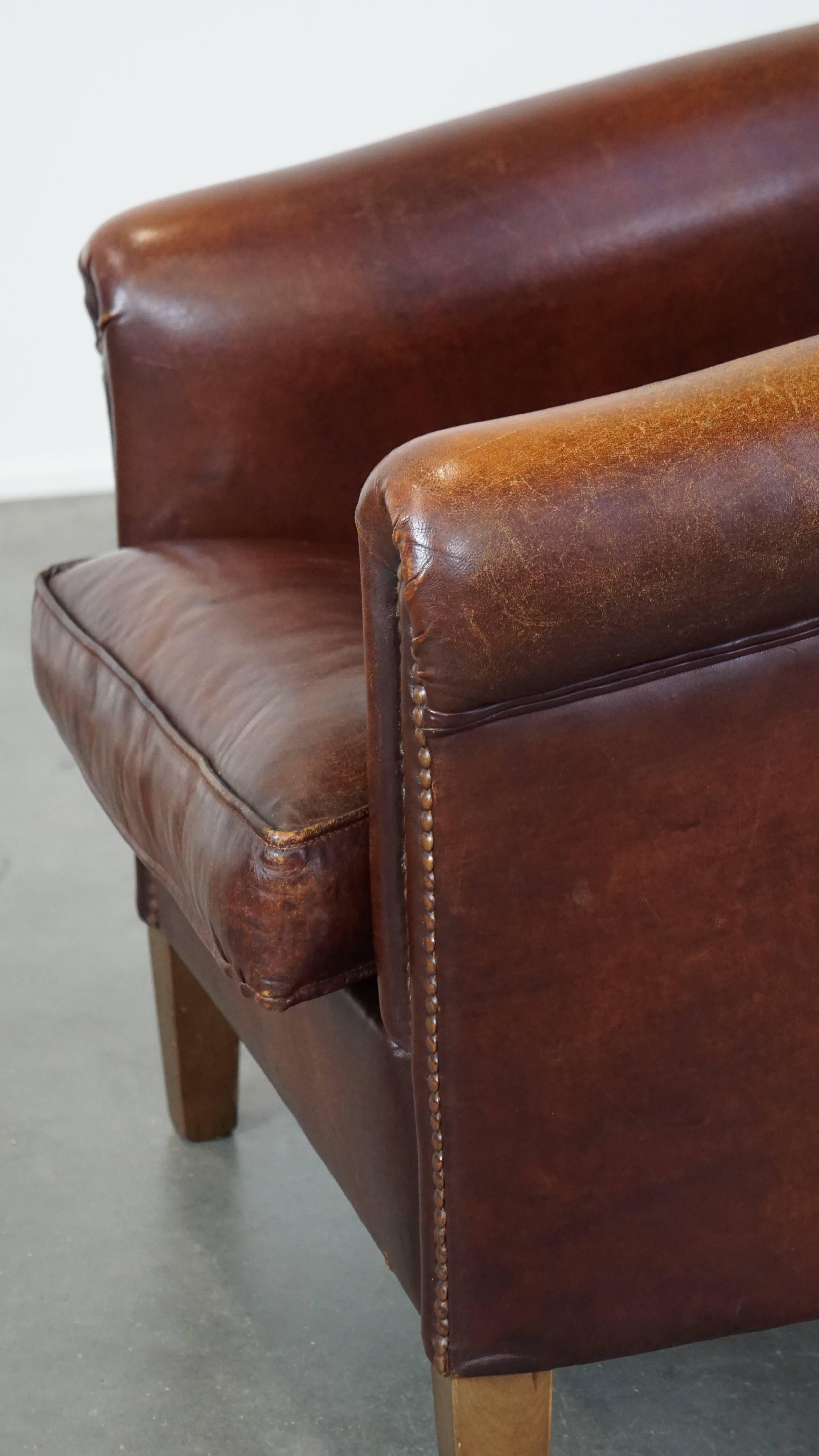 Stately, charming sheepskin club chair, correct finishing with decorative nails For Sale 2