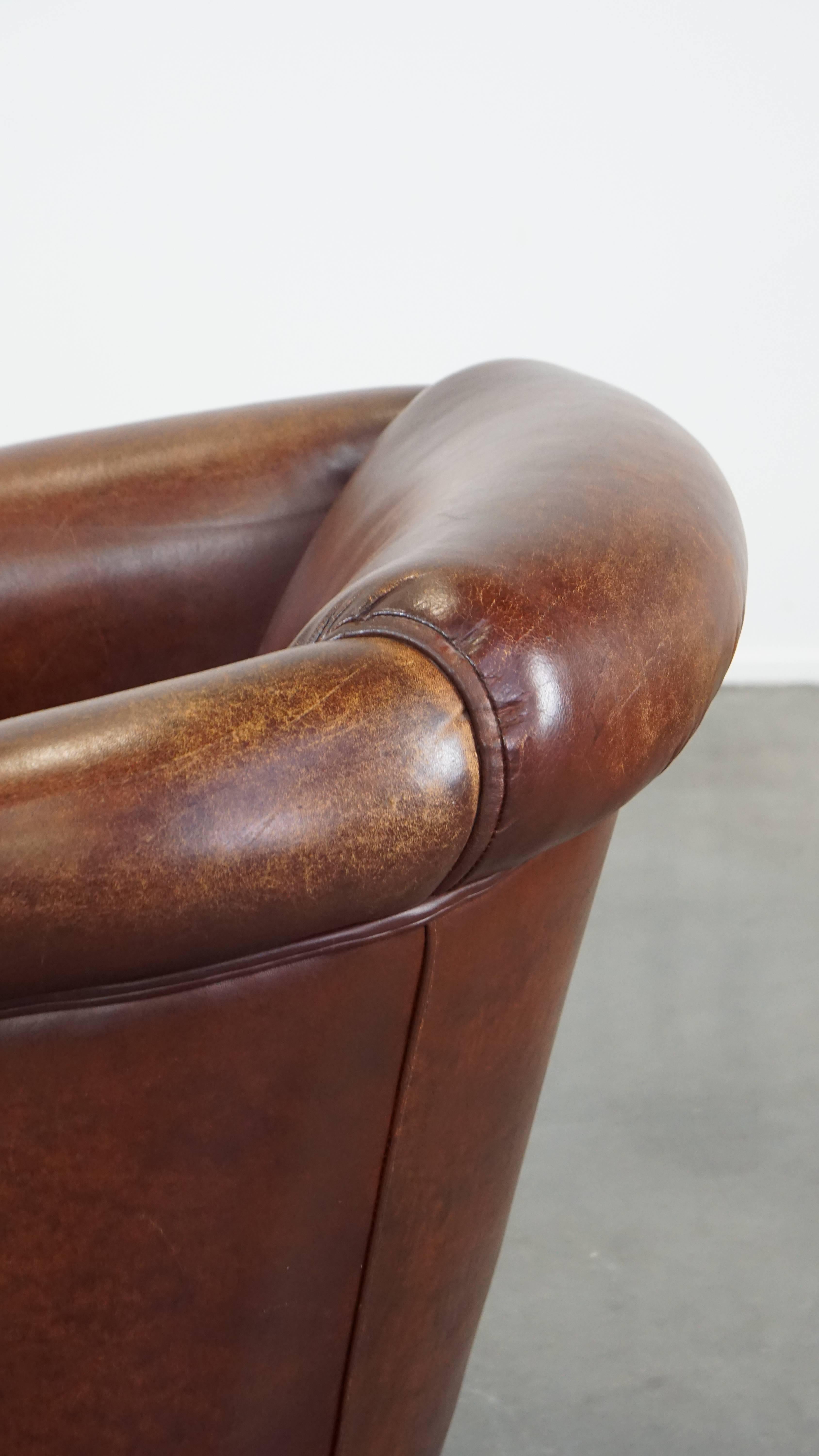 Stately, charming sheepskin club chair, correct finishing with decorative nails For Sale 3