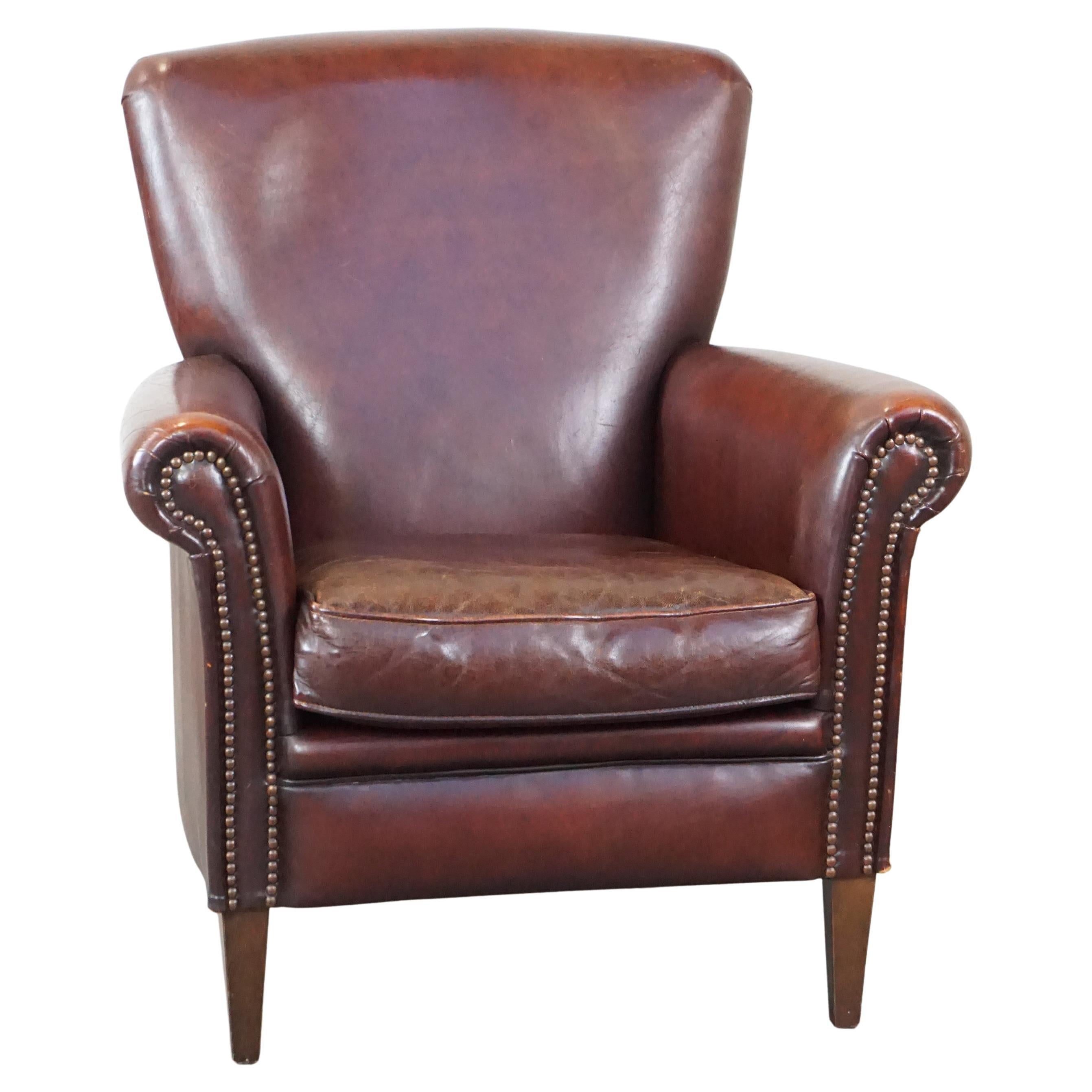 Stately, comfortable sheepskin armchair with proper finish and decorative nails