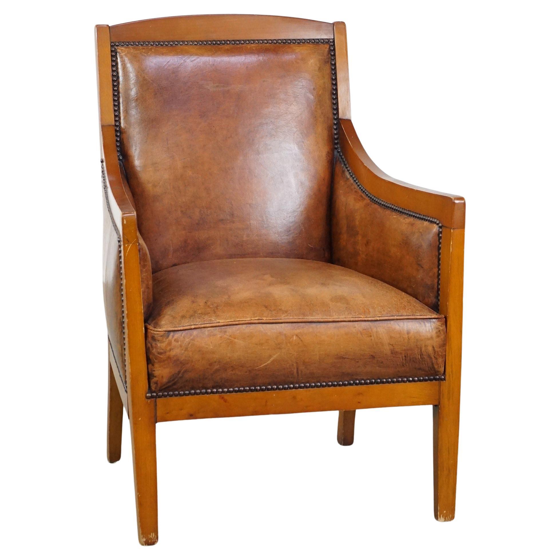 Stately, luxurious sheepskin leather Art Deco design armchair combined with wood