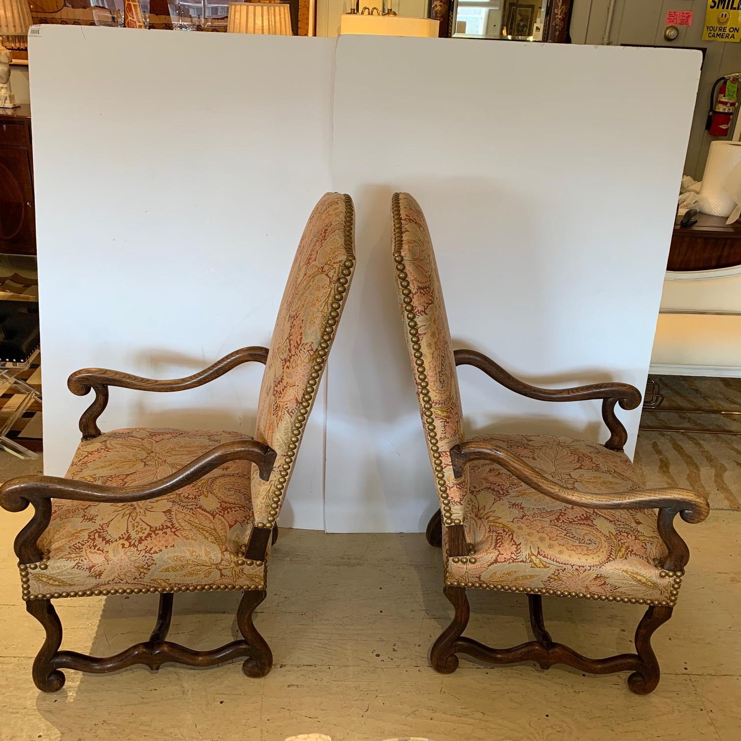 A classy pair of antique English armchairs having curved walnut arms, undulating stretchers and curved feet. Upholstery within the last 10 years is top of the line earth colored paisley and floral Brunschwig and Fils.
Measures: 47” H x 23” W x 29”