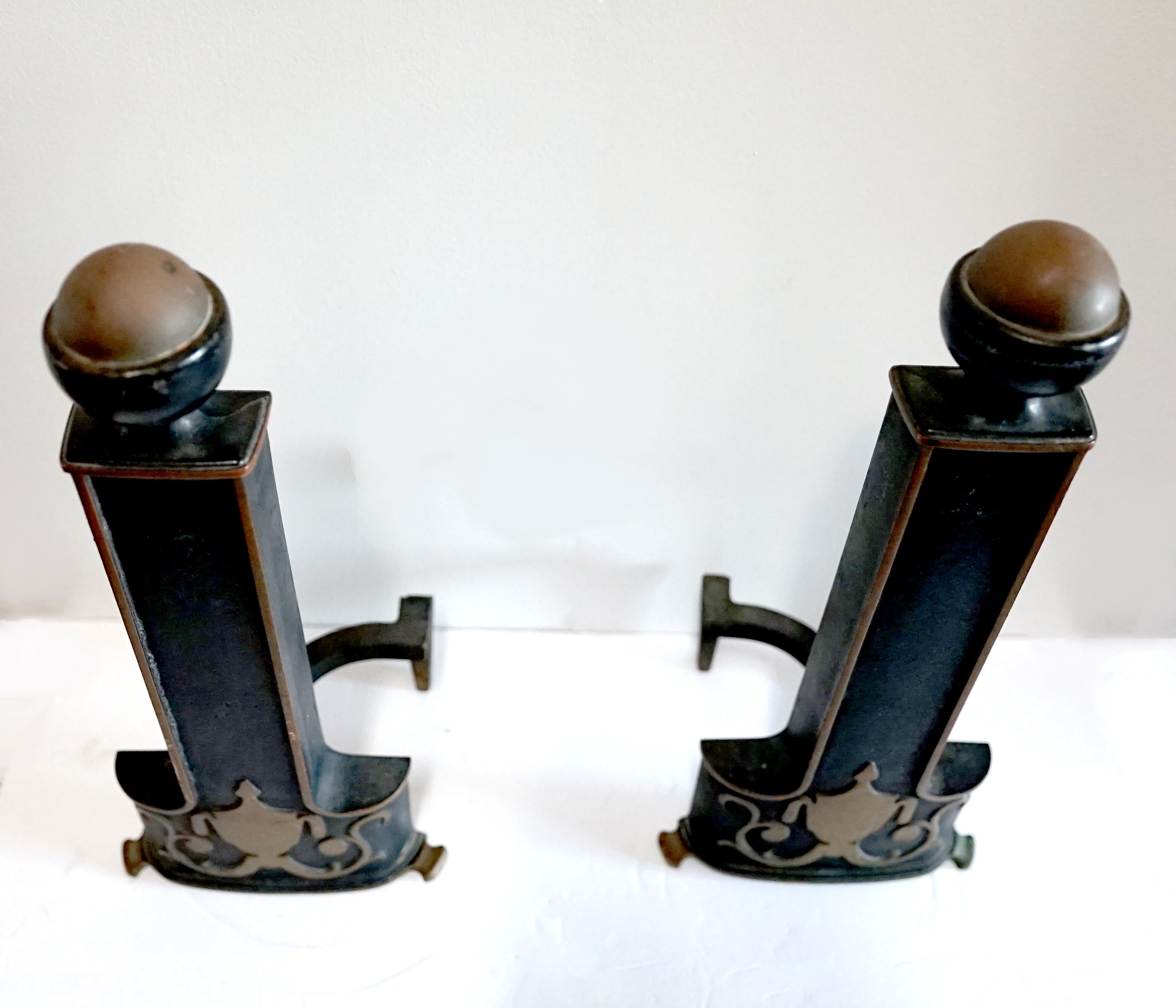We love this pair of andirons for its stately air. The pair of Neoclassical style ebonized copper ball-top andirons are probably European, and from the early 20th Century. They are distinctive pieces for any hearth. 
Each surmounted by a copper ball