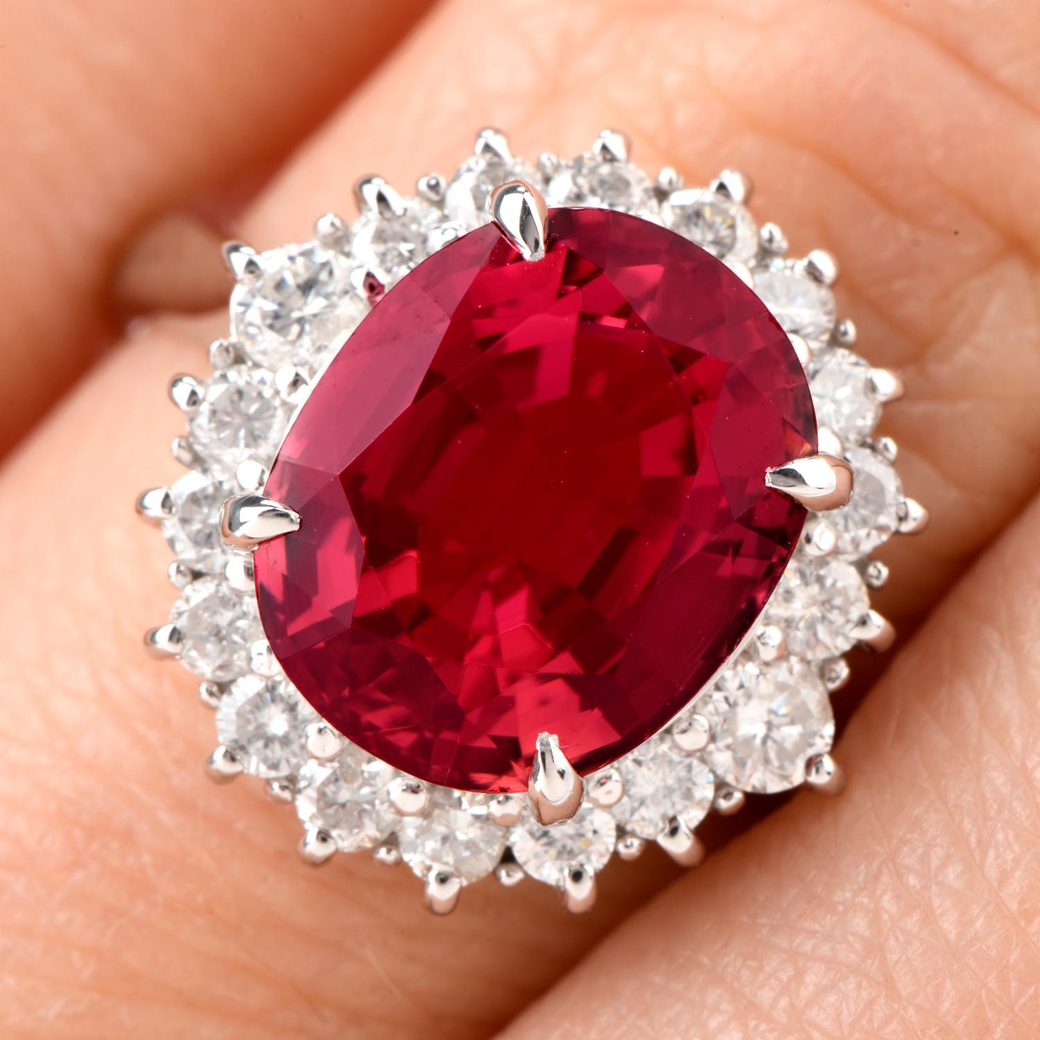 This Diamond and Pink Tourmaline ring comes with the versatility  of being worn as an engagement ring of color or a stately cocktail ring and was crafted in Platinum. Adorning the center is an oval shaped deep and rich colored Pink Tourmaline
