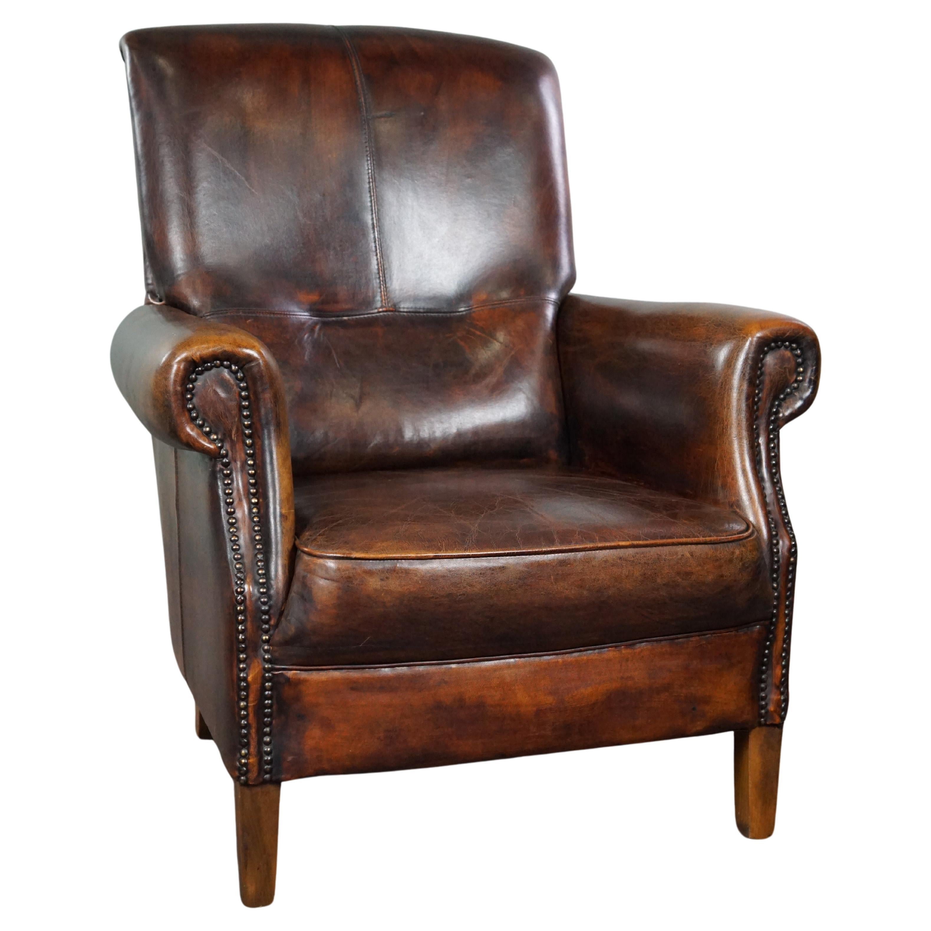 Stately sheep leather armchair, comfortable seat, and high back For Sale