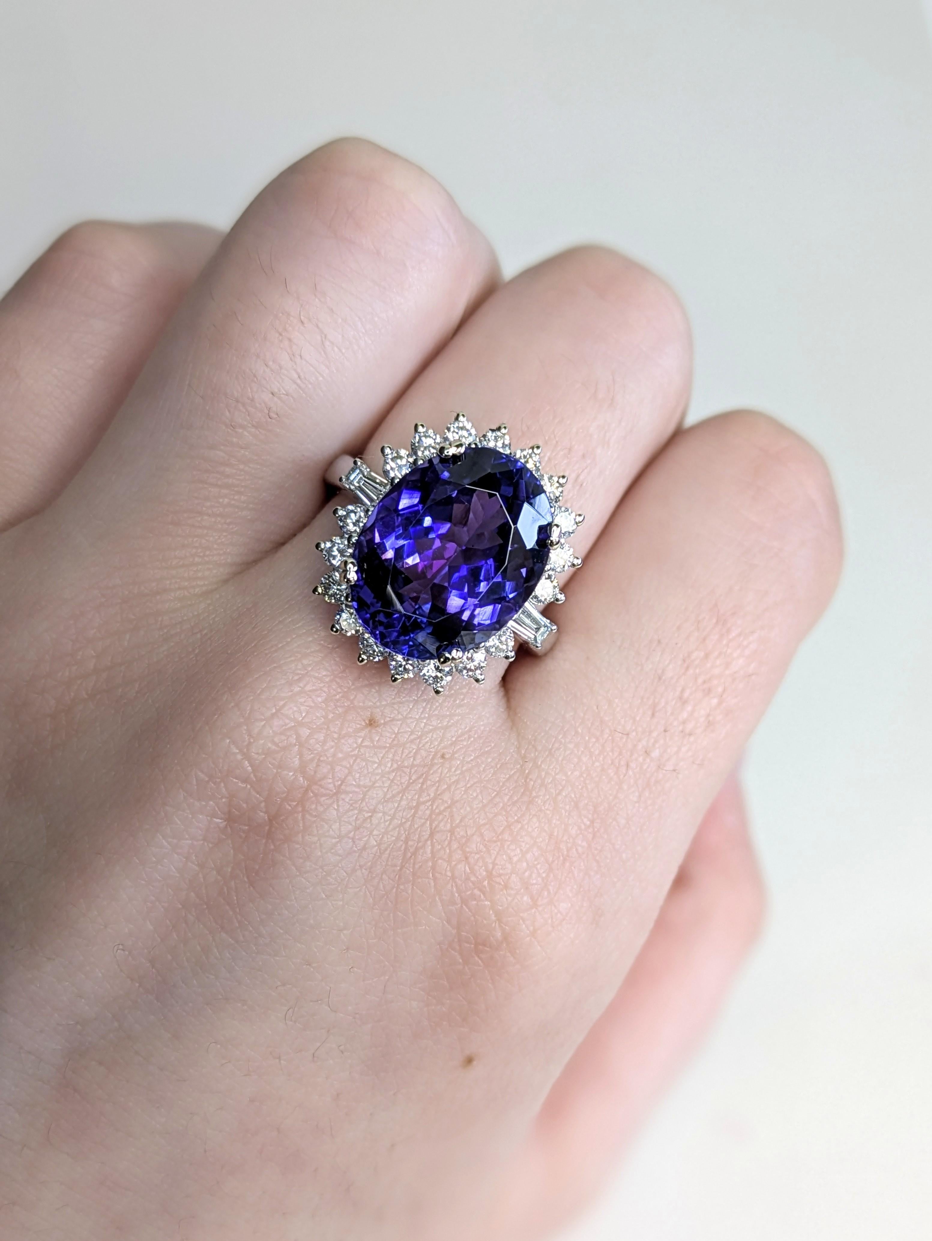 Make an unforgettable impression with this luxurious 8.93 carat oval 13x10mm Tanzanite ring. Nestled in a halo of sparkling earth-mined diamonds and set in solid 14K white gold, this piece is as bold as it is refined. Its vivid color and commanding