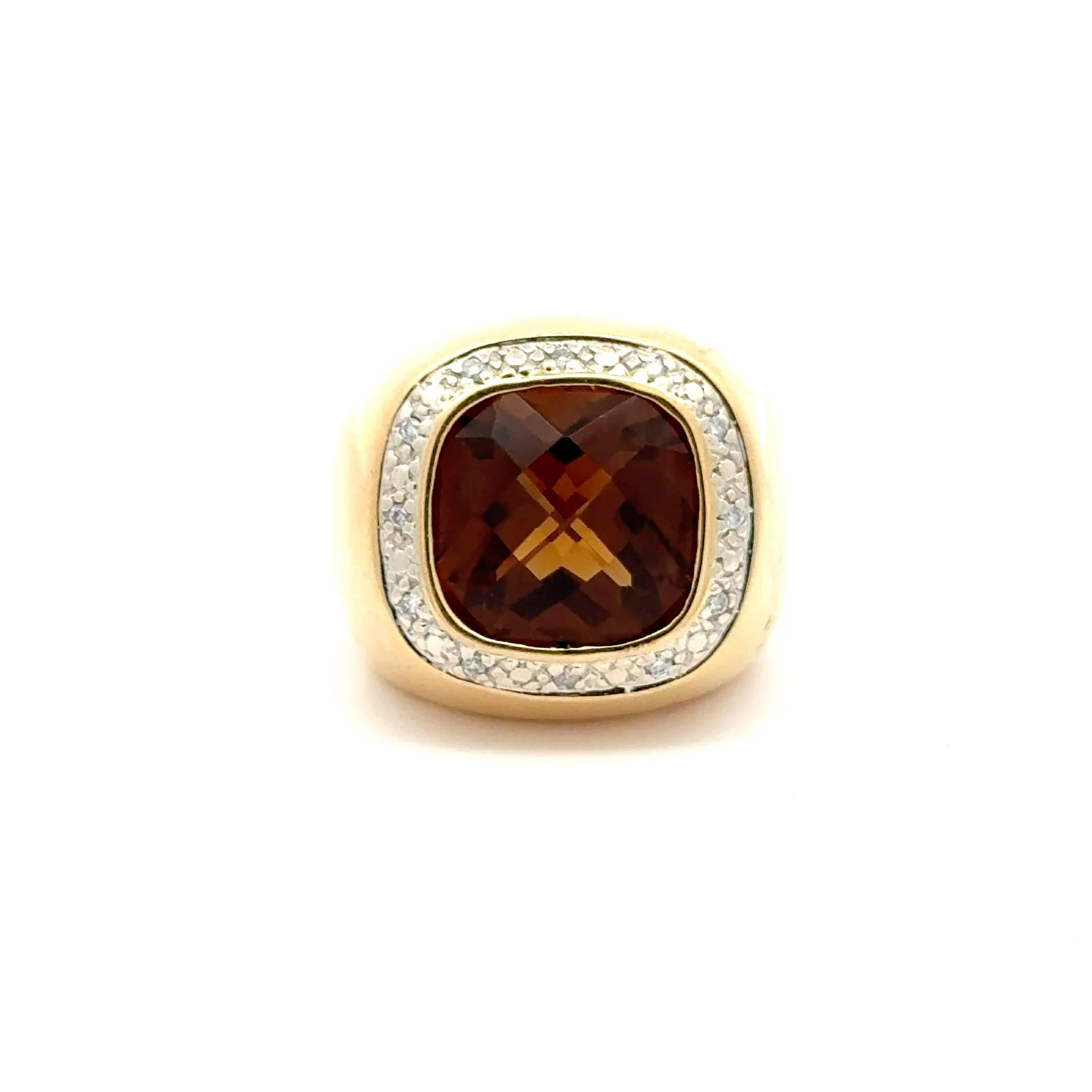 A bold and luxurious design, this vintage 14K yellow gold ring centers a striking 5.00-carat cushion-cut citrine in a rich amber hue. Framed by a halo of sparkling round diamonds totaling approximately 0.20 carats, the ring offers a powerful