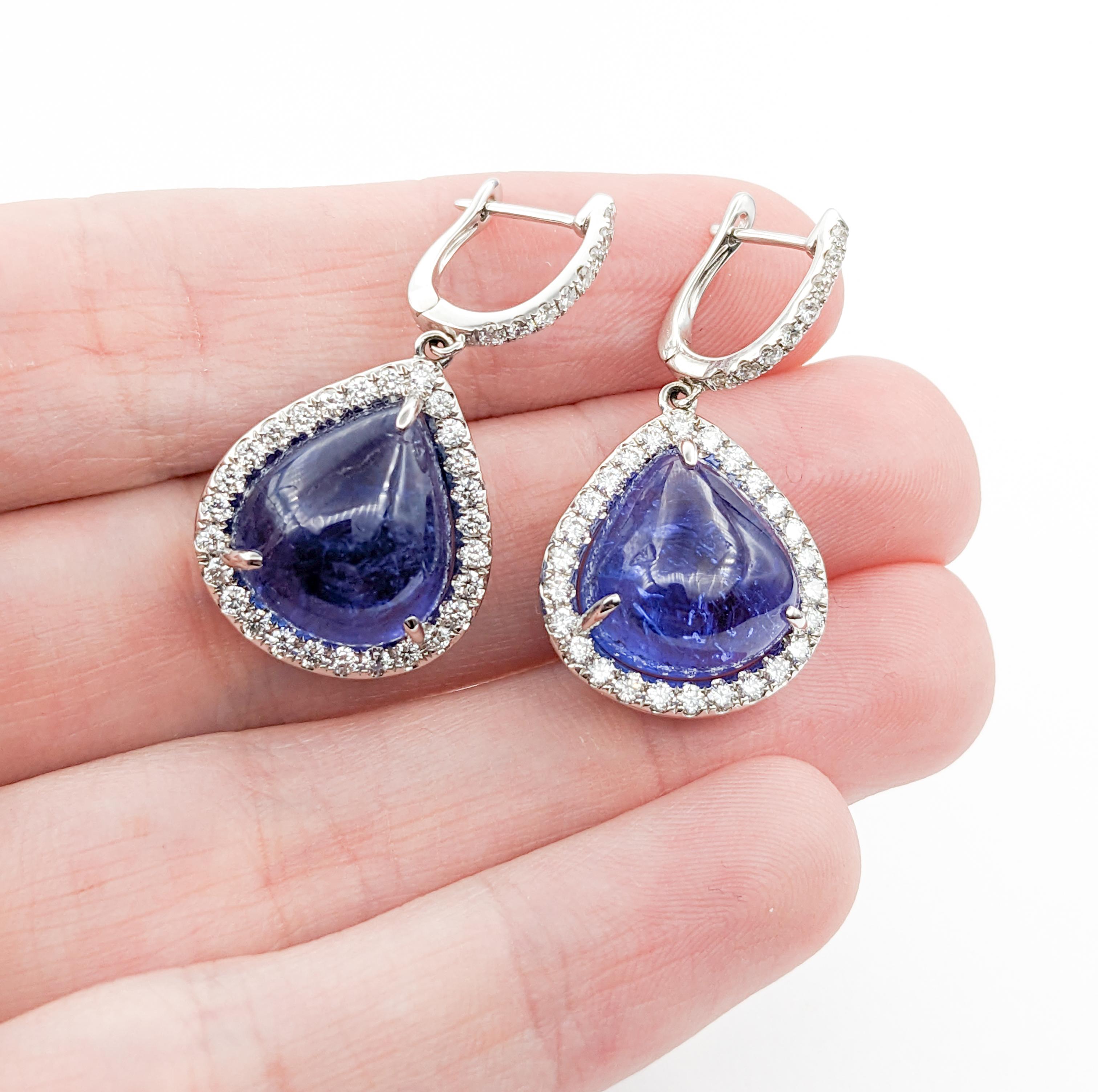 Statement 20.07ctw Cabochon Tanzanite & Diamond Drop Earrings

Introducing these exquisite earrings, meticulously crafted in 14k white gold, adorned with 1.13ctw of sparkling round diamonds. The diamonds, with their impressive SI1 clarity and G