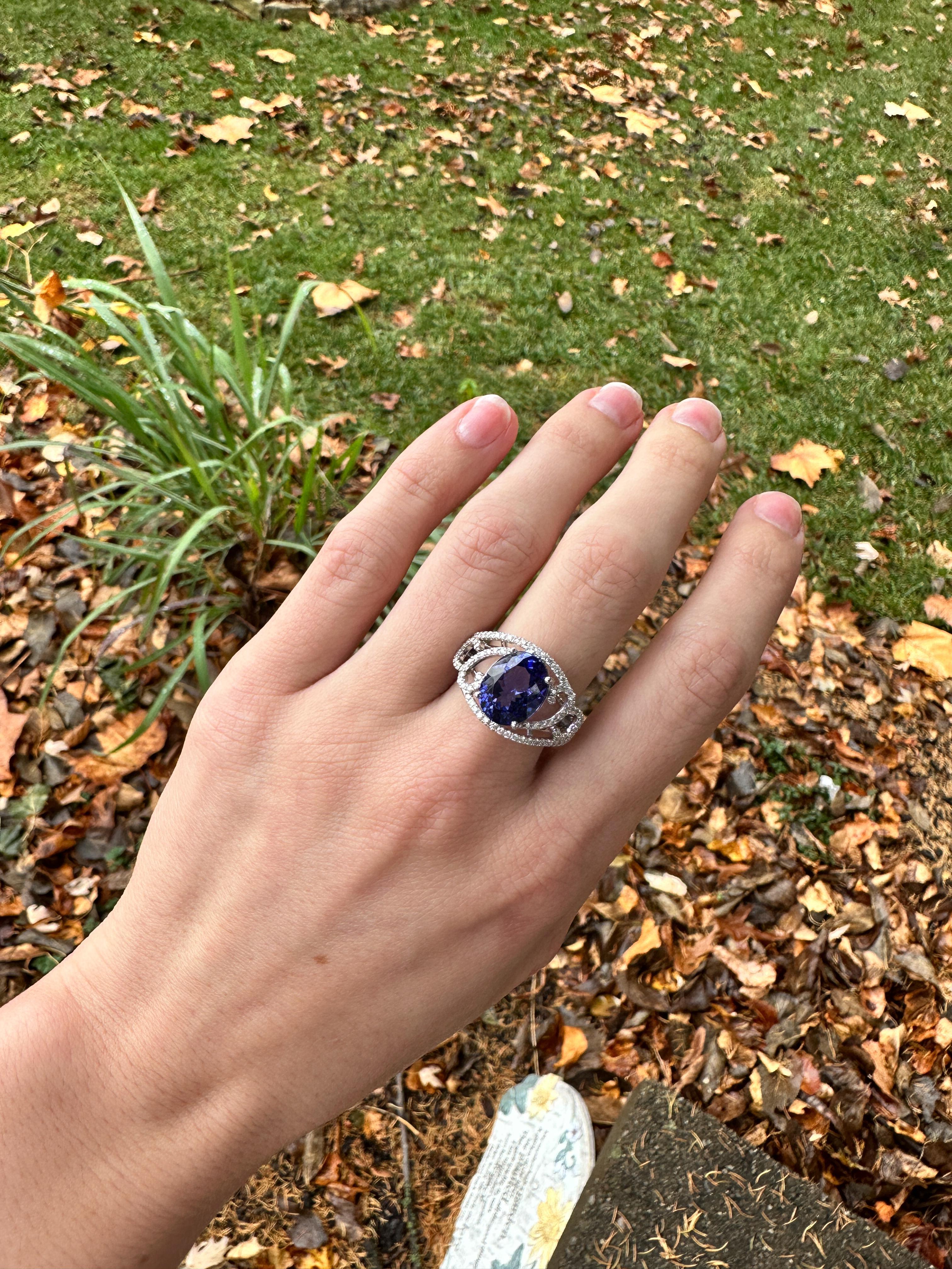 Enhance your look with this gorgeous tanzanite ring featuring a stunning 5.4ct oval-shaped tanzanite and sparkling earth mined diamonds, set in solid 14K white gold. Make a statement with this elegant and sophisticated piece.

**We offer