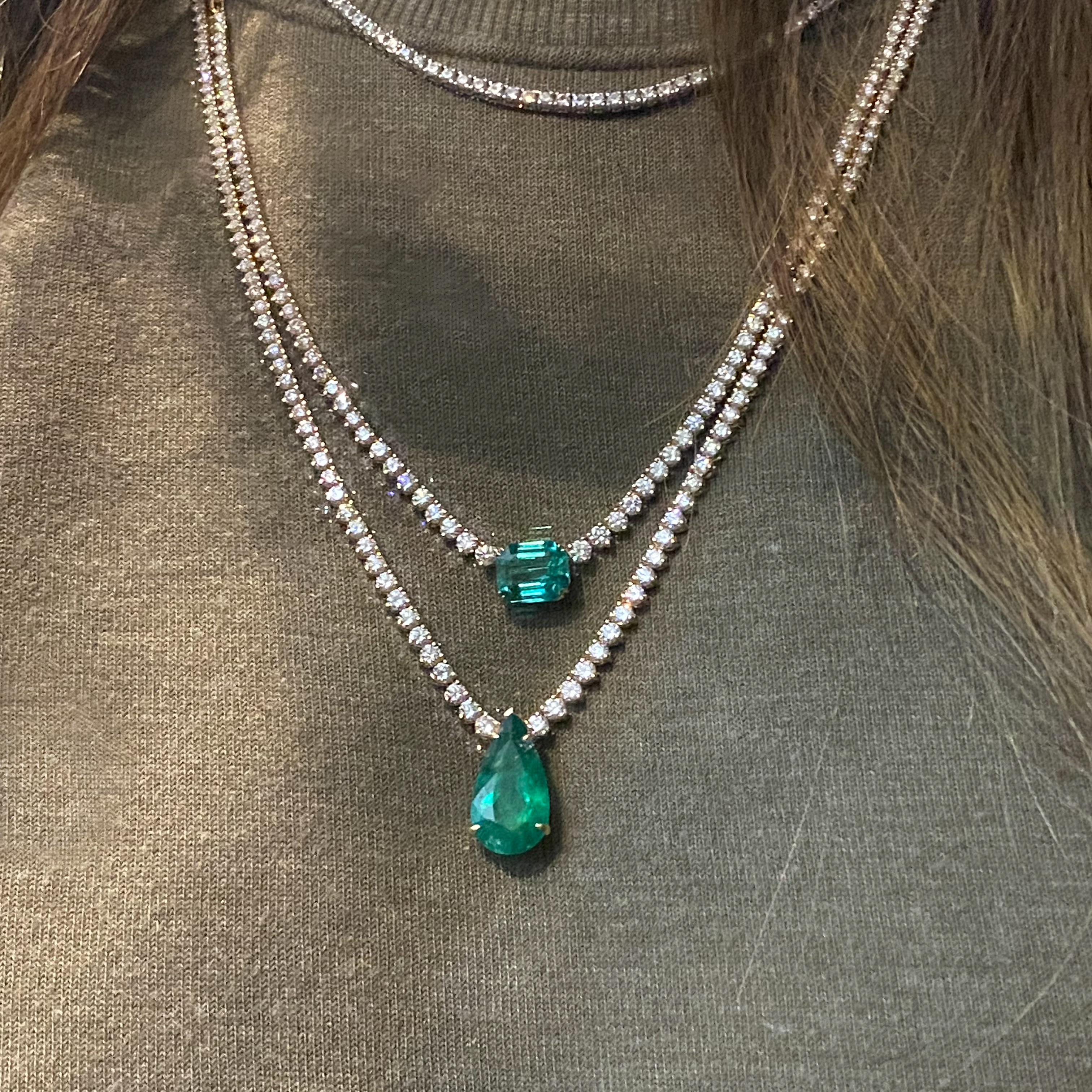 Significant 7.3 ct Emerald drop pendant on a 24-inch, half-way graduated Diamond and chain necklace with 5ct round Diamonds set in 18k yellow gold.

This design is also available in 7.5ct Emerald and all-around Diamond necklace.