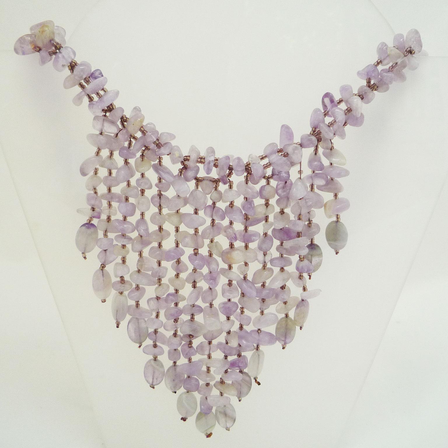 Statement amethyst necklace
Opulent necklace made of rose´farbenen natural stones. 
Two interwoven strands of cut amethysts carry a pendant of chains of different lengths (up to 14 cm) of this precious natural stone.
Handmade, modern design