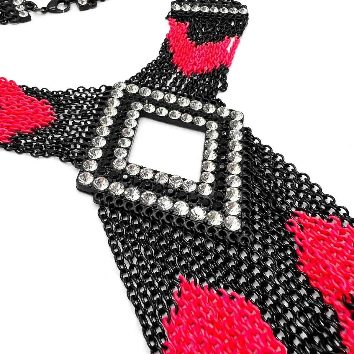 A Statement Neon & Black Tasselled Panel Necklace. Blackened metalwork contrasts to perfection with the neon pink and rhinestone panels. The finishing tassel giving an air of movement and freedom. An absolute stunner that will be certain to turn