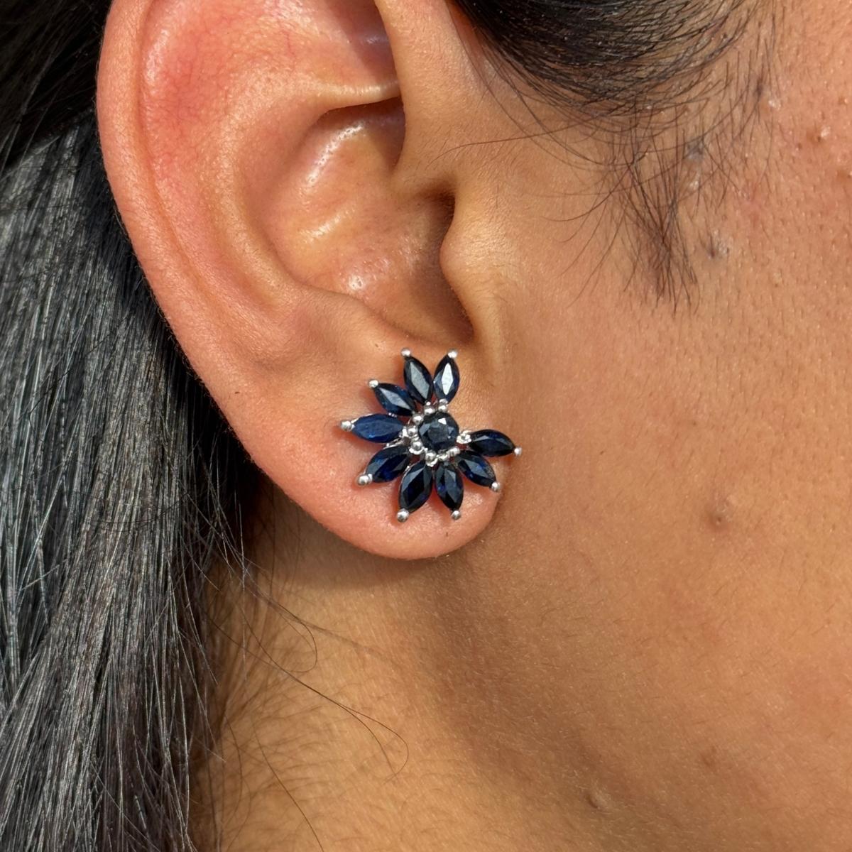 Statement Blue Sapphire Flower Stud Earrings in sterling silver to make a statement with your look. You shall need stud earrings to make a statement with your look. These earrings create a sparkling, luxurious look featuring marquise, round cut