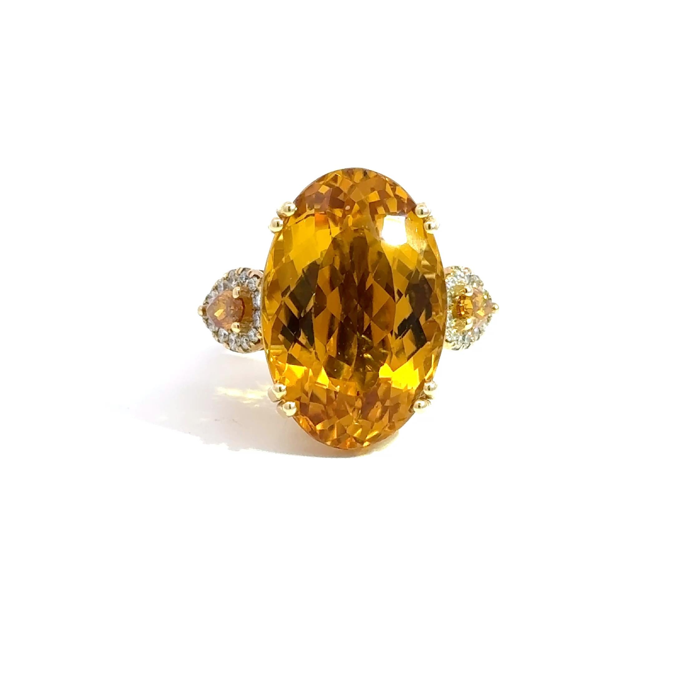 A show-stopping vintage-inspired cocktail ring featuring a vivid 20.51-carat oval citrine set in luxurious 14k yellow gold. This bold and elegant centerpiece is flanked by two rare pear-shaped natural orange diamonds totaling 1.08 carats, surrounded