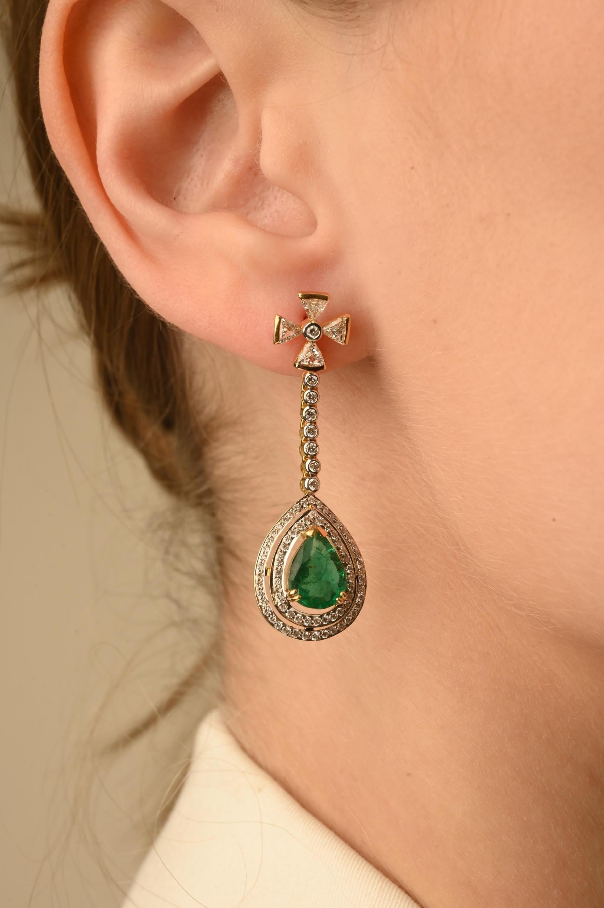 Emerald Dangle Drop Earrings in 14K Gold with Diamonds to make a statement with your look. These earrings create a sparkling, luxurious look featuring pear cut gemstone.
Emerald enhances the intellectual capacity. 
Designed with pear cut emerald