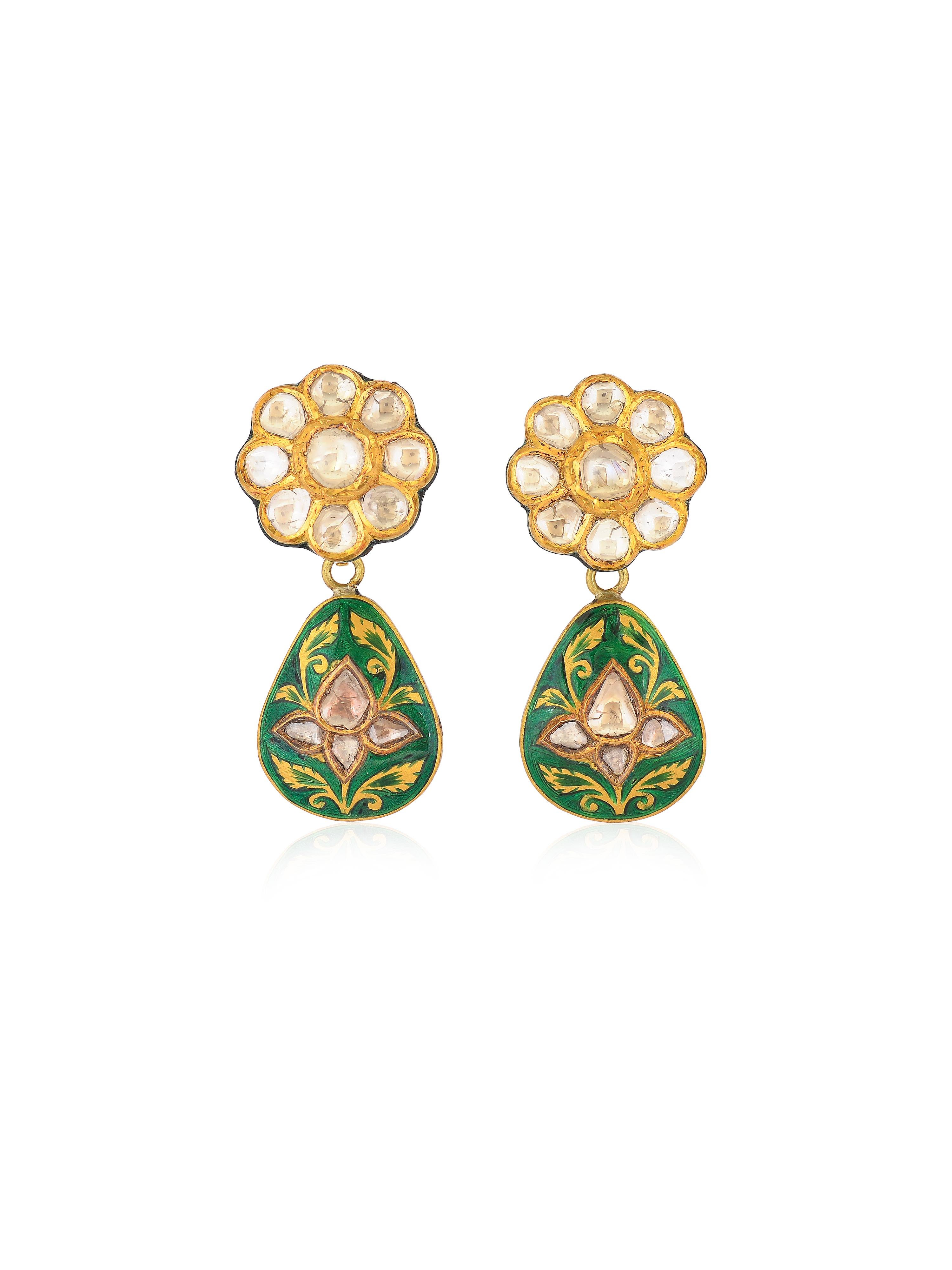 A beautiful statement earrings with green enamel and flat uncut diamonds. The diamonds are set in a very old traditional Mughal way of setting that you will notice in antique pieces as well. They are surround by a layer of pure gold called 'Kundan'