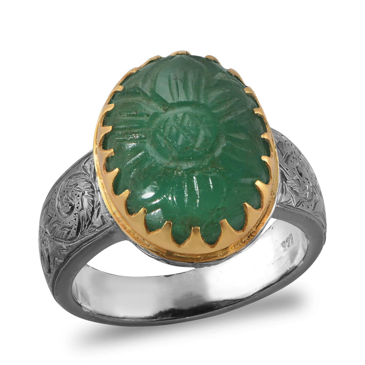 

This fabulous one of a kind ring has been handmade in our workshops. It has a hand carved emerald in the centre, set in 18k gold. The shank of the ring which is made in oxidized sterling silver has exquisite Mughal Art work inscribed on it.

Ring