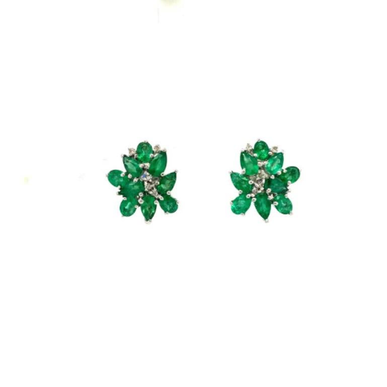 Statement Emerald Cluster and Diamond Stud Earrings in sterling silver to make a statement with your look. You shall need stud earrings to make a statement with your look. These earrings create a sparkling, luxurious look featuring oval, pear cut