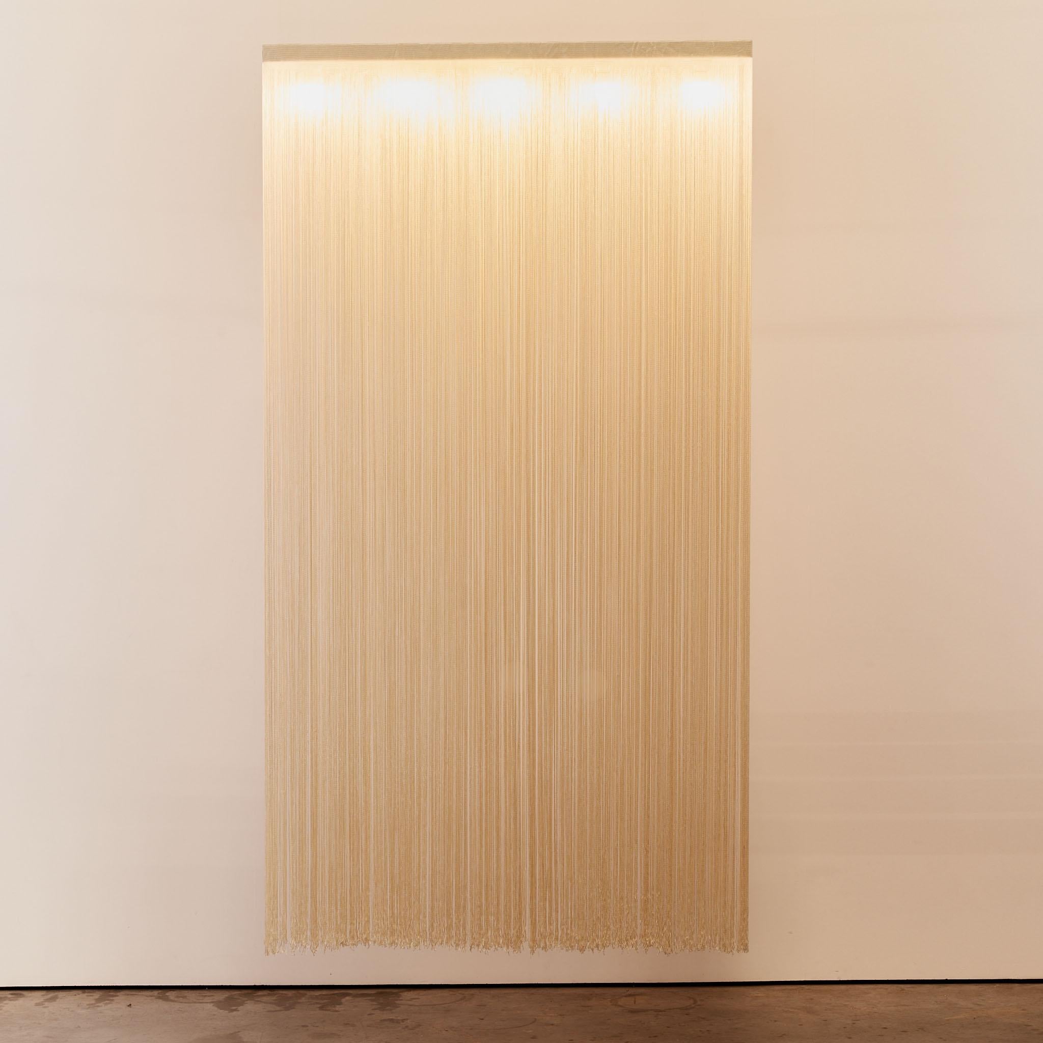 Garbo fringed ceiling light with steel light box that houses 5 bulbs and omits an ambient light, manufactured in Italy by Sirrah. This needs to be hard wired into the ceiling. 

Mariyo Yagi was born in 1948 in Kobe, Japan. Her best-known works, the