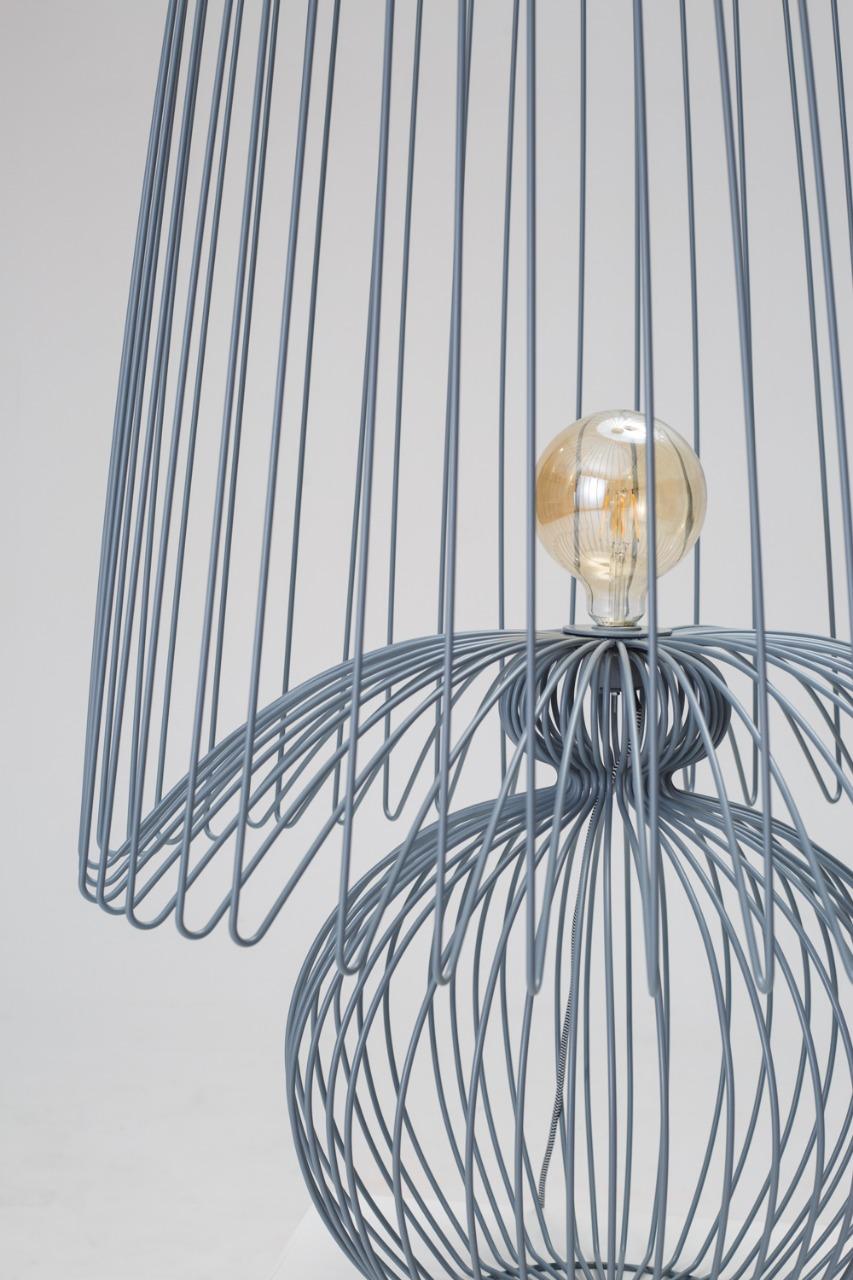 Achieving perfect harmony between light and transparency, this handmade wired piece can be used either for lighting or as a contemporary decorative item and statement lamp. With its distinctive design derived from rounded wire shapes and an imposing