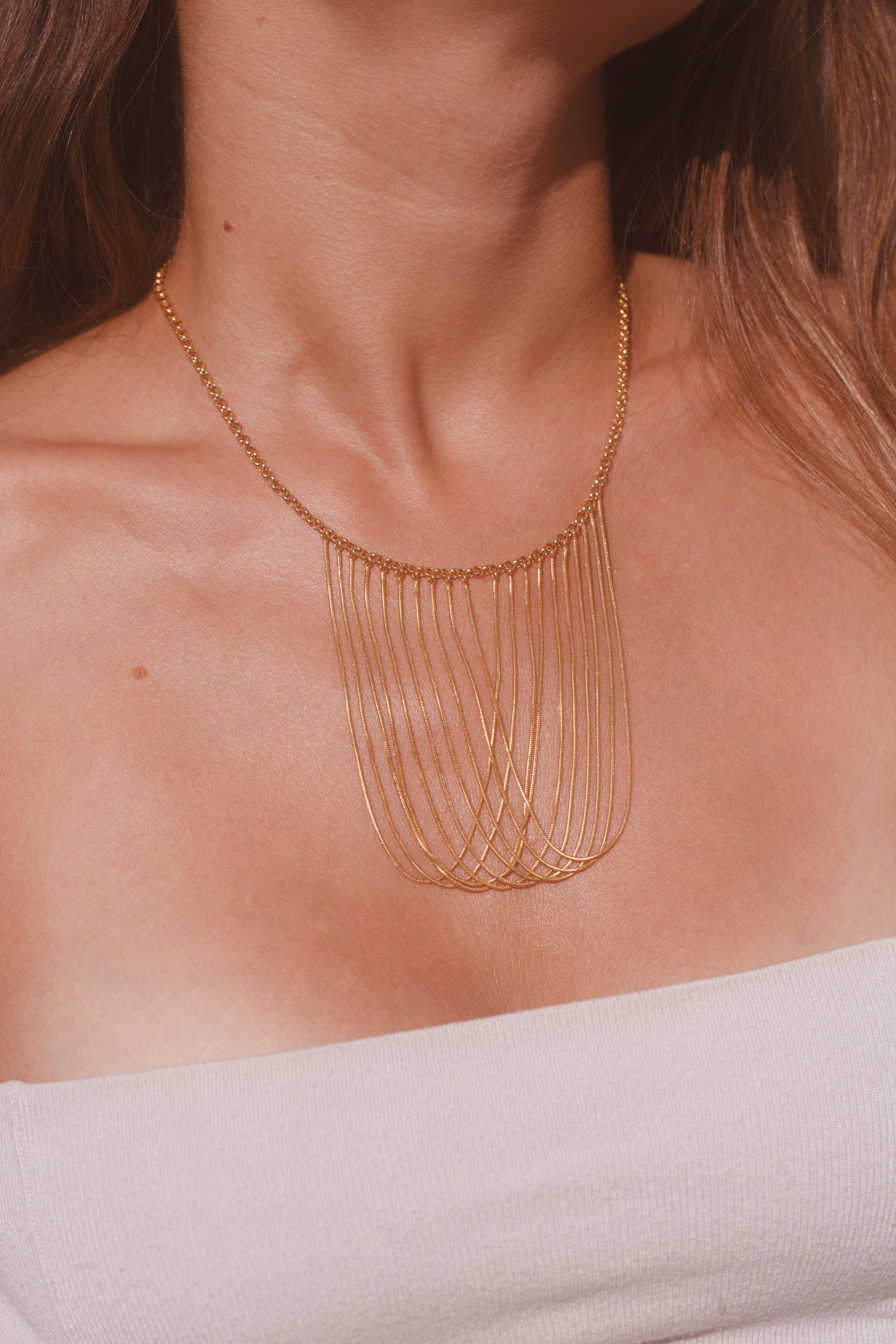 18k- rose gold plated brass statement necklace created to compliment and curess a woman's neckline. The movement of the snake chain creates a shiny liquid effect offering a very strong look. Every chain has been individually hand-cut and placed by