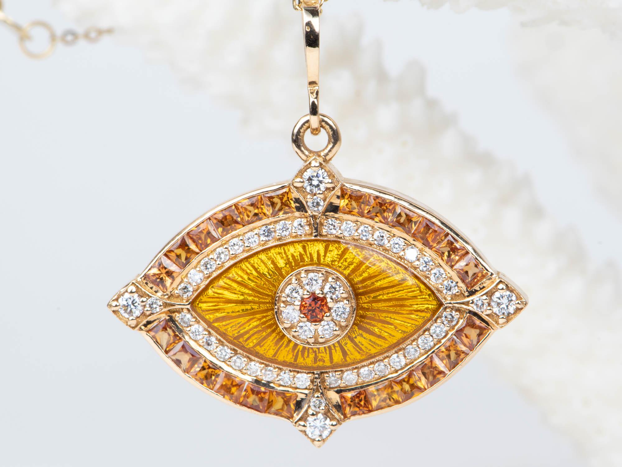 ♥ A solid 18K gold evil eye pendant featuring gorgeous princess-cut orange sapphires and diamonds
♥ This pendant features an inner halo of guilloche enamel
♥ The pendant measures 20mm in length, 24.2mm in width, and 4.8mm thick.
♥ Material: 18K