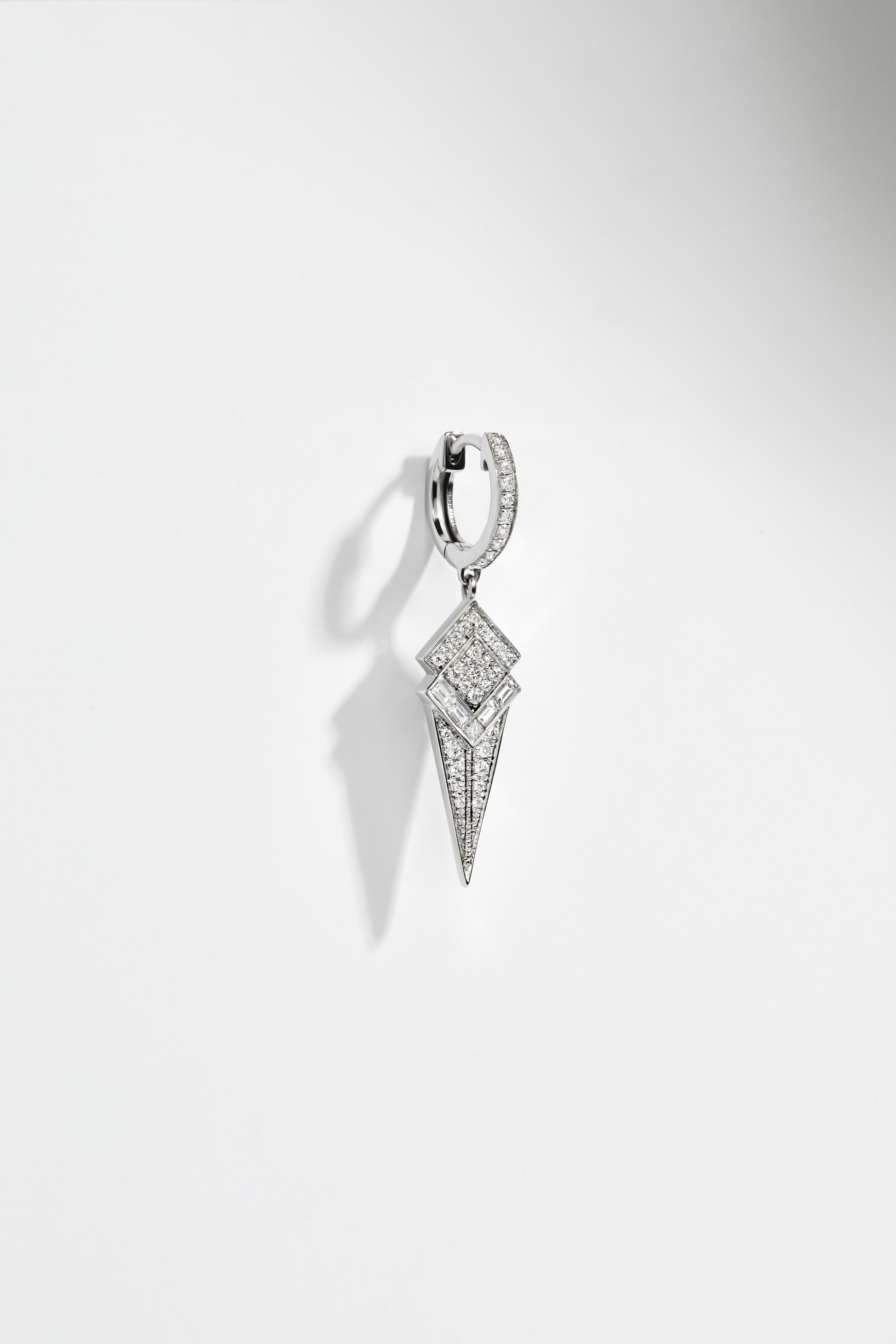 Hoop Stairway Cone in rhodium plated sterling silver, set with 39 brilliant-cut diamonds and 4 baguette-cut diamonds, quality G-VS, totaling 0,25 carat. 

This conical-shaped hoop is made of rhodium plated sterling silver paved with white diamonds.
