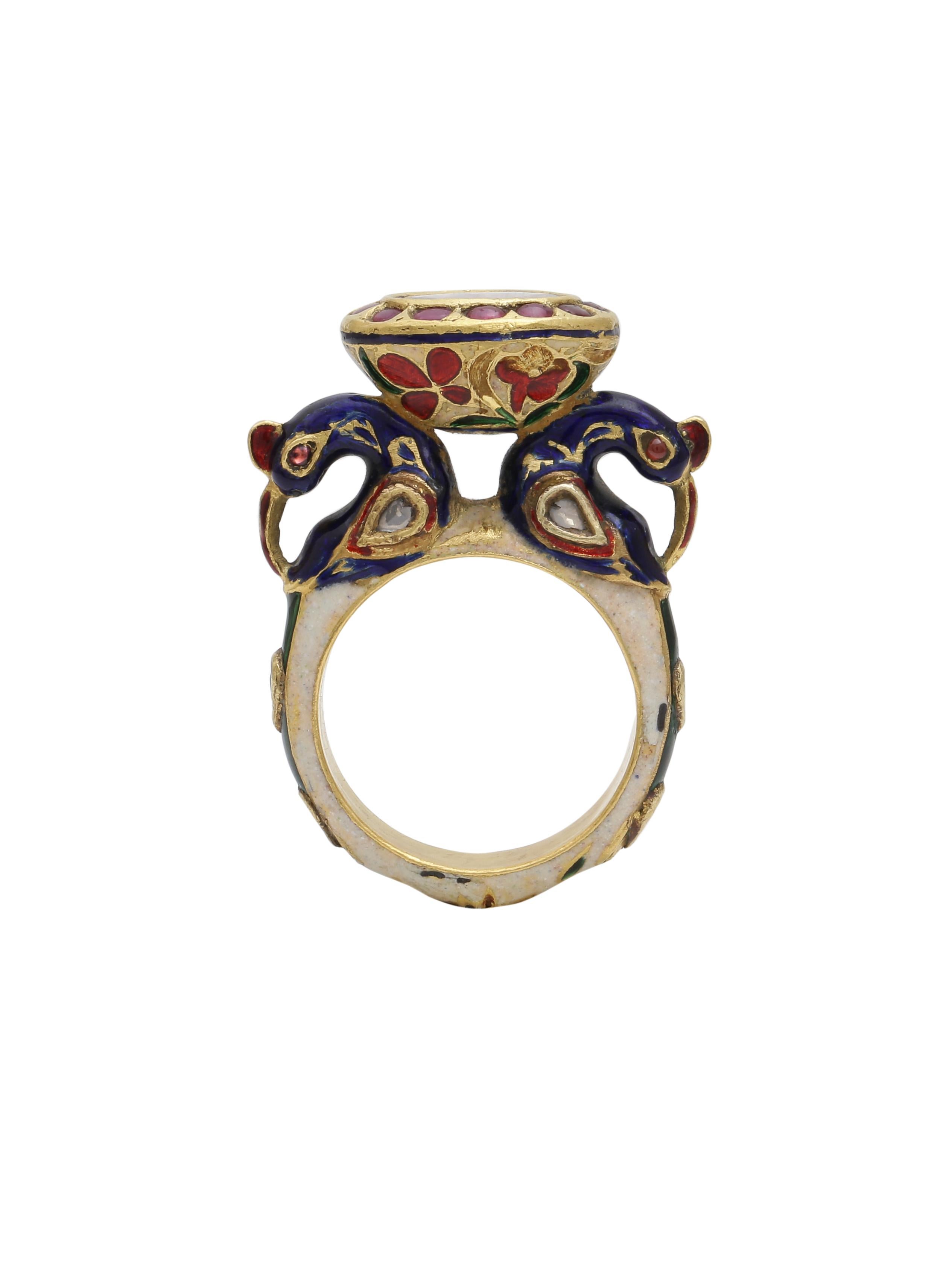 A beautiful cocktail ring with a Rosecut Diamond in the centre and intricate enamel all over the ring. Holding the beautiful Diamond are 2 peacocks also handcrafted in gold with blue enamel and diamonds to show detailing in the bird.
The ring is