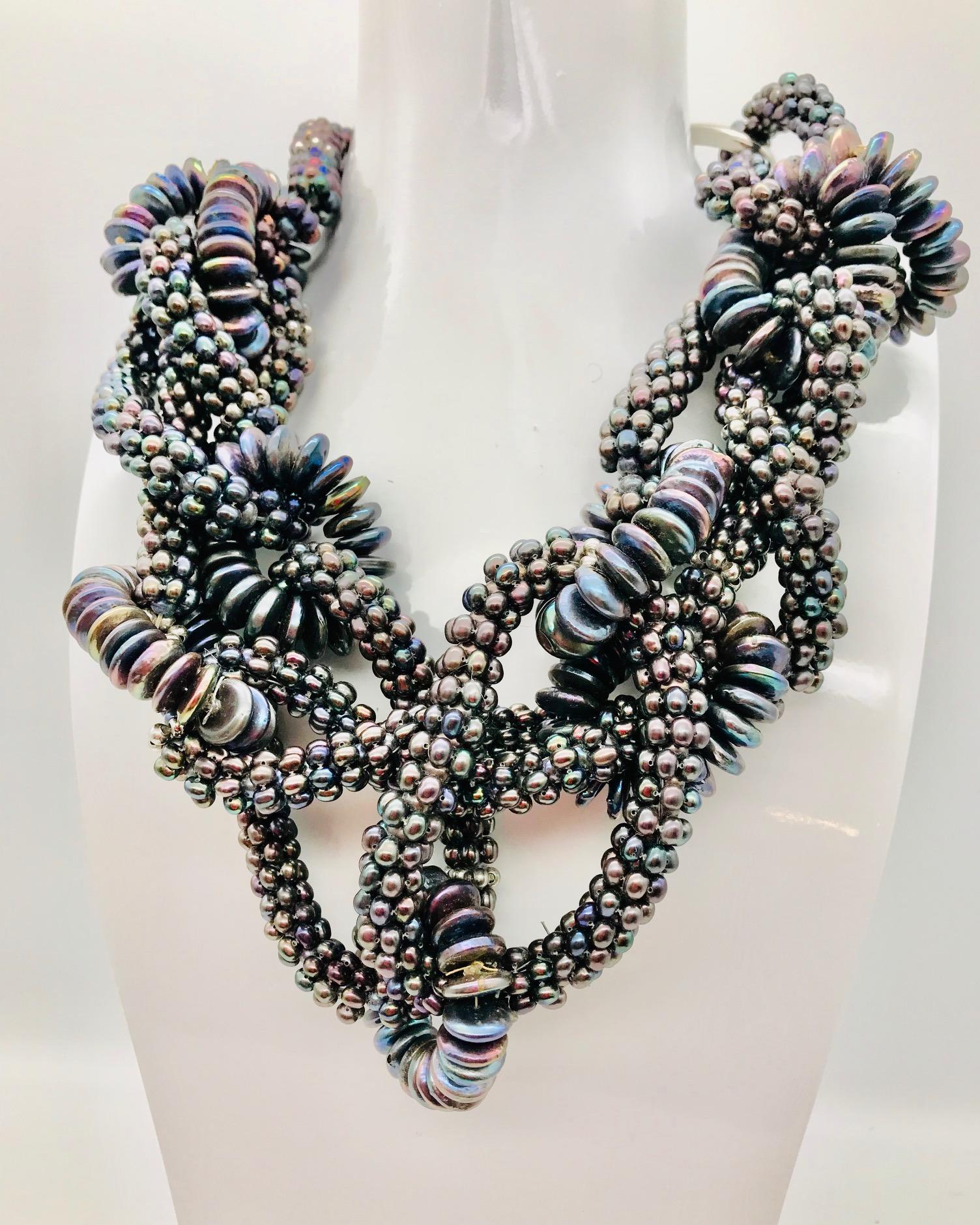  Black Pearl necklace shown is made of number of circular loops joined and composed into a necklace. It was a very labor intensive design because the  tiny 1/8' dark fresh water round pearls made into loops and held together by 1/4