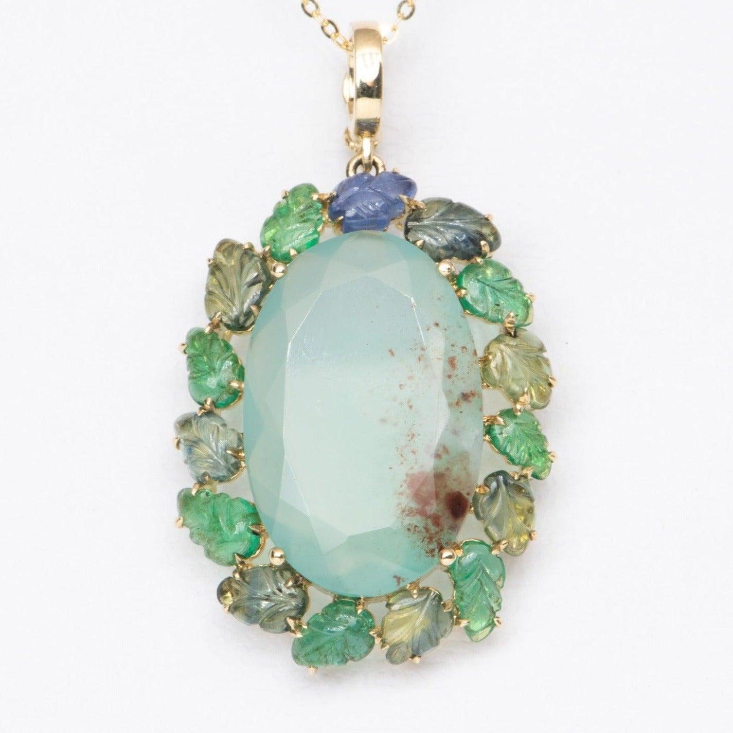 ♥ A solid 9K gold statement pendant set with a stunning Aquaprase in the center, flanked by Emerald and Sapphire carved leaves
♥ The setting measures 42.7 mm in length, 25 mm in width, and 7.4 mm thick

♥ Material: 9K Yellow Gold
♥ Gemstone: