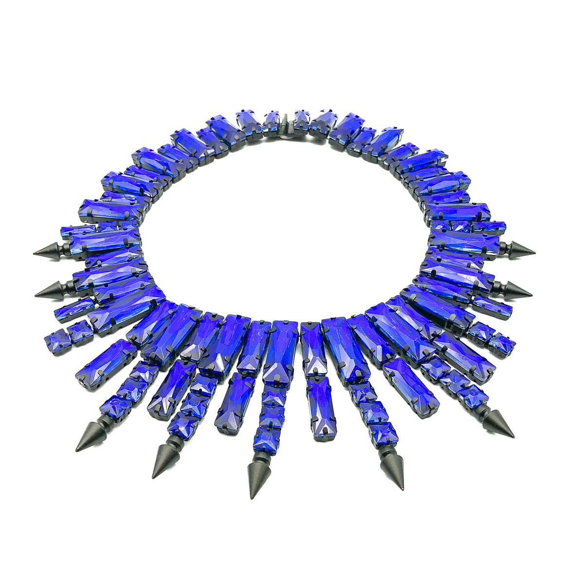 A statement Petrol Blue Glass Collar. Vibrant, fancy cut electric blue stones sit within a blackened metal setting. All stones are claw set. Very good condition, approx. 44.5 cms length and 7cm drop. A stunning preloved statement collar that is
